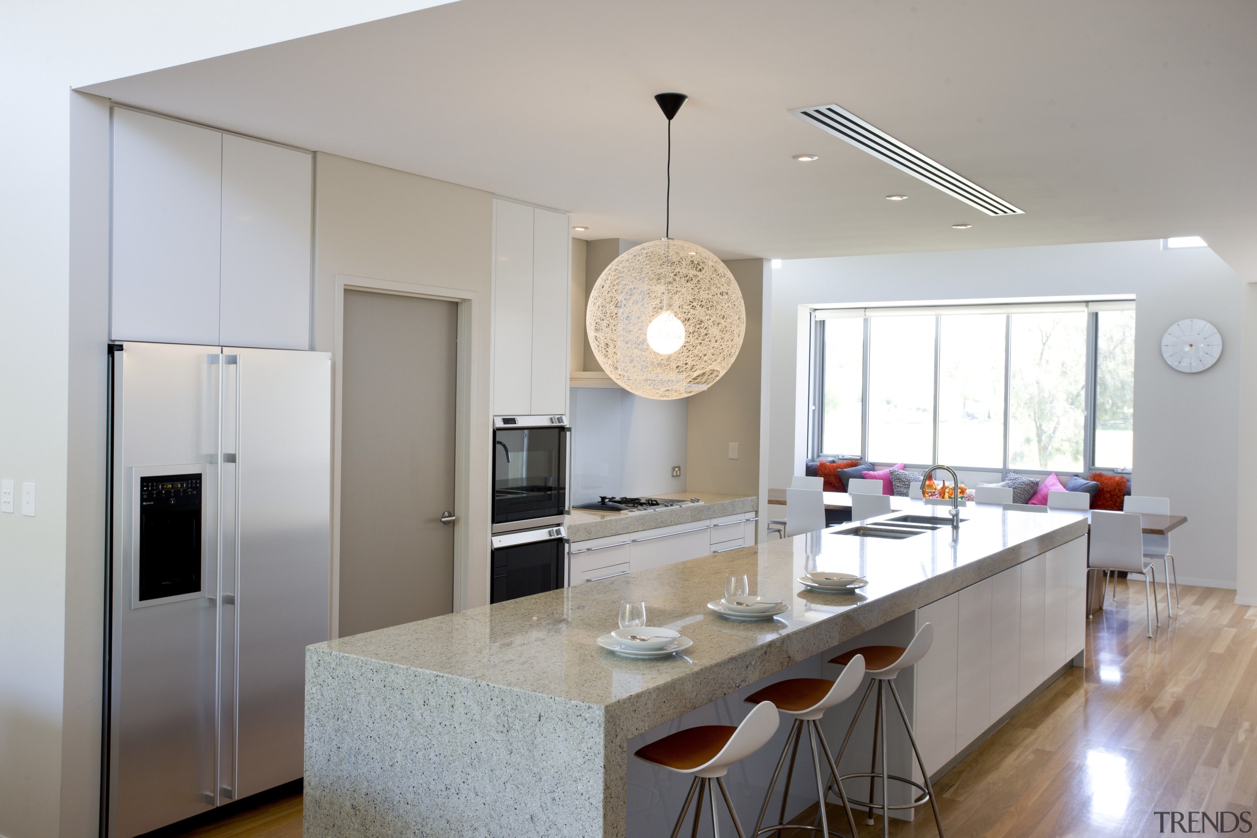 The island in this new kitchen is both countertop, cuisine classique, interior design, kitchen, real estate, room, gray