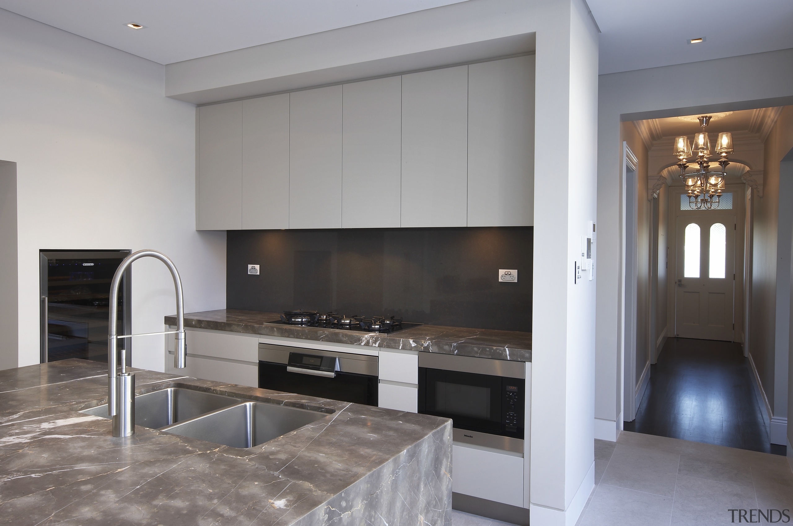 Grey and brown marble island benchtop, white walls, countertop, floor, flooring, interior design, kitchen, real estate, room, gray