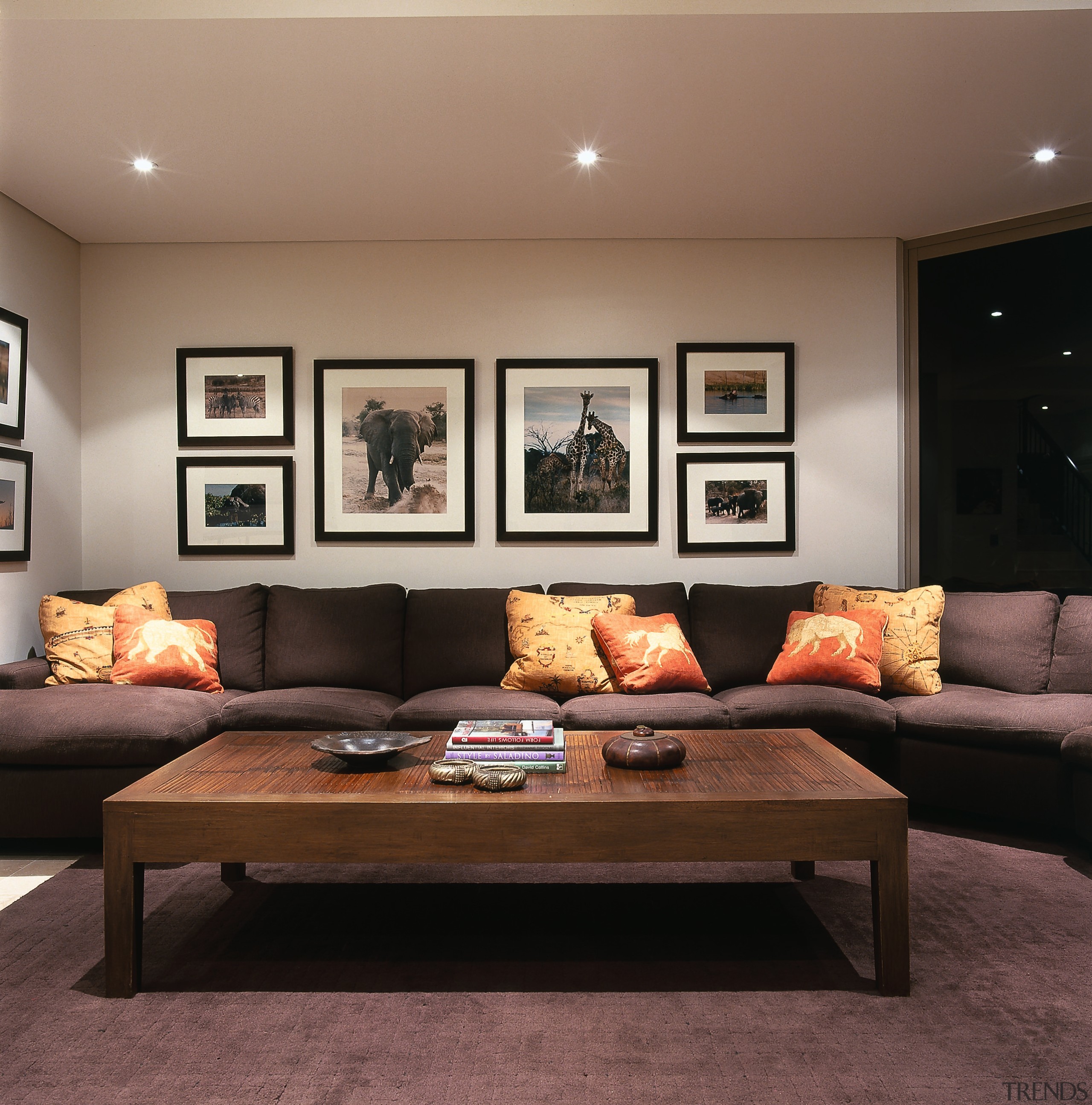 A view of the family room with African ceiling, coffee table, couch, floor, flooring, furniture, home, interior design, living room, loveseat, room, table, wall, black, brown