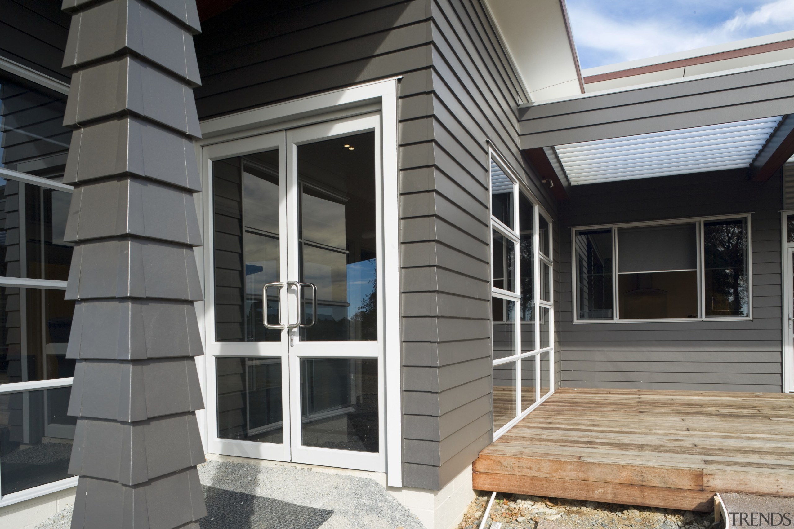 At the Eastgate Centre, muted colours were selected door, facade, home, house, porch, property, real estate, siding, window, gray, black