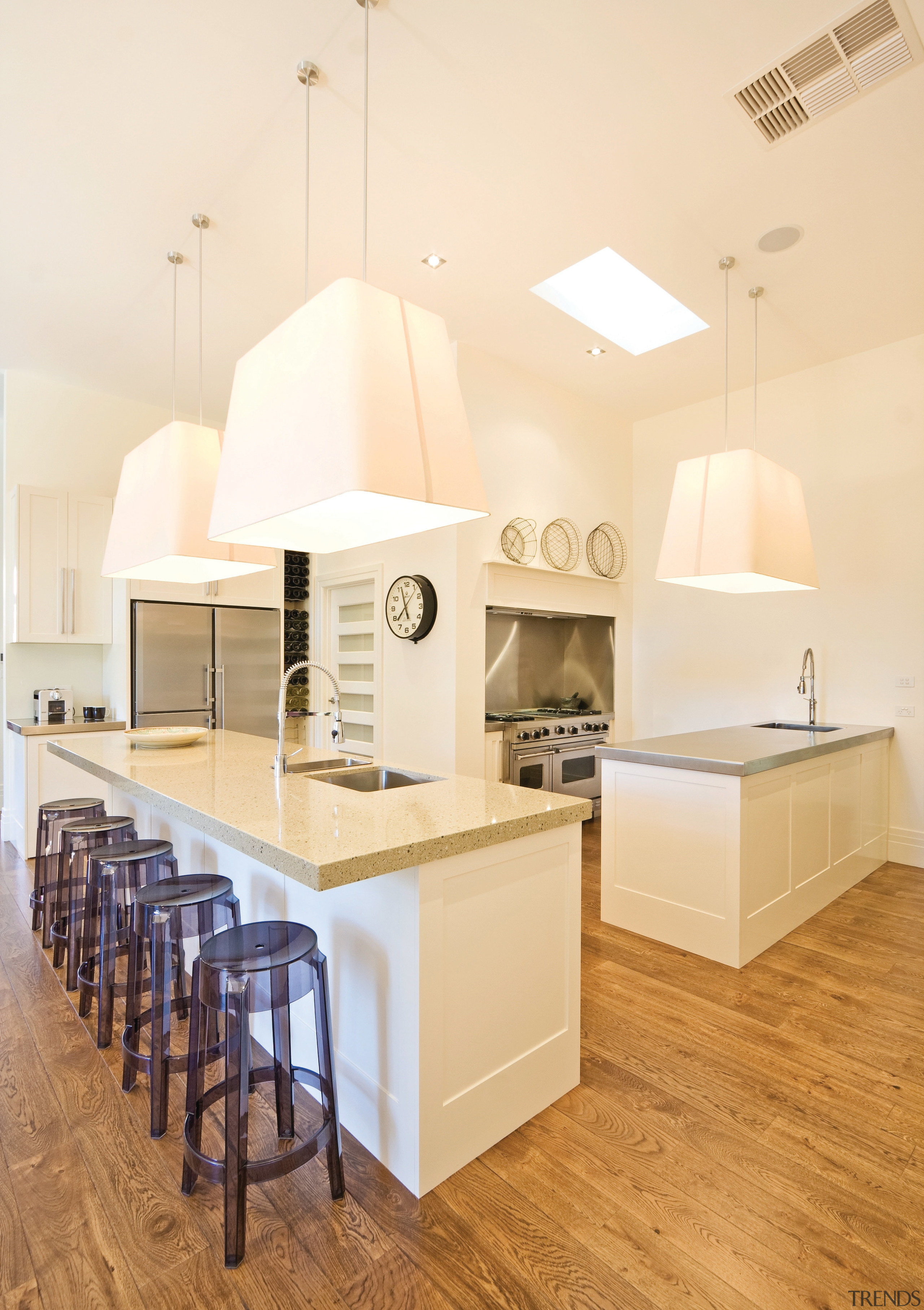 View of a kitchen featuring long island with ceiling, countertop, floor, flooring, home, interior design, kitchen, product design, room, table, wood flooring, orange