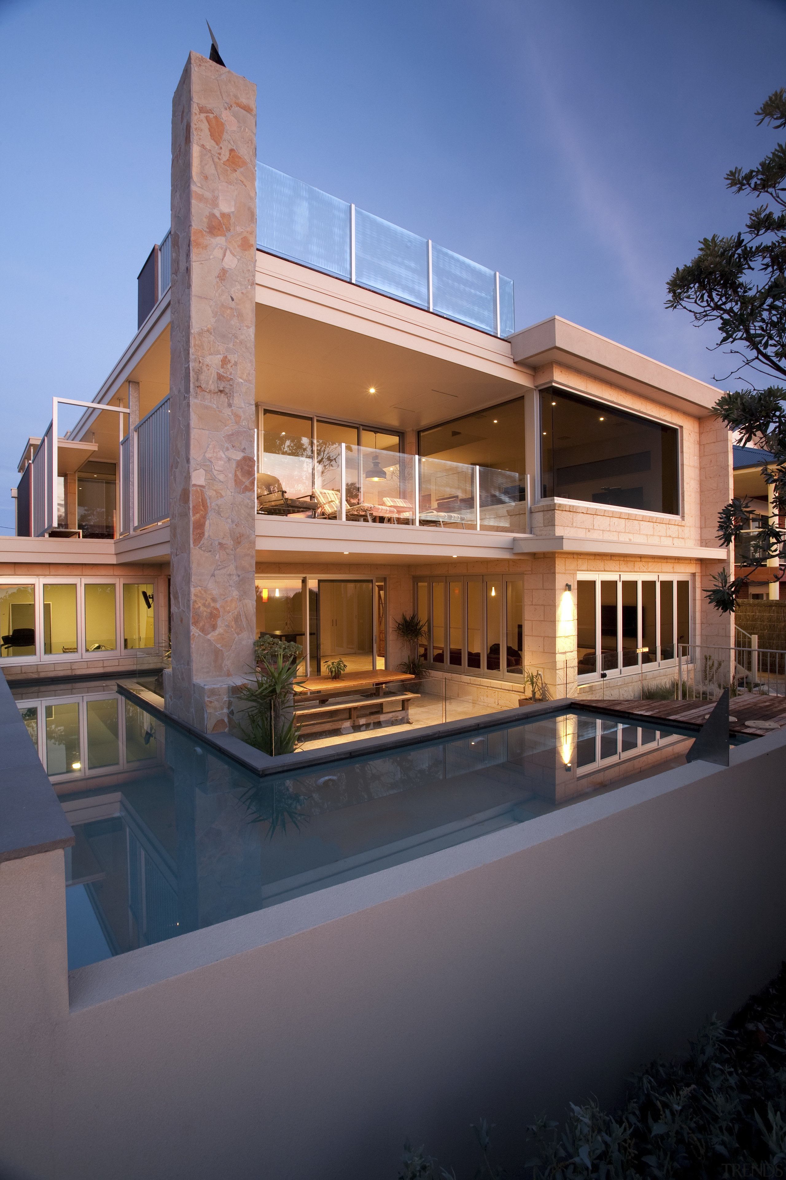 View of contemporary home with dark cabinetry, wooden apartment, architecture, building, condominium, elevation, estate, facade, home, house, mixed use, property, real estate, reflection, residential area, villa, window