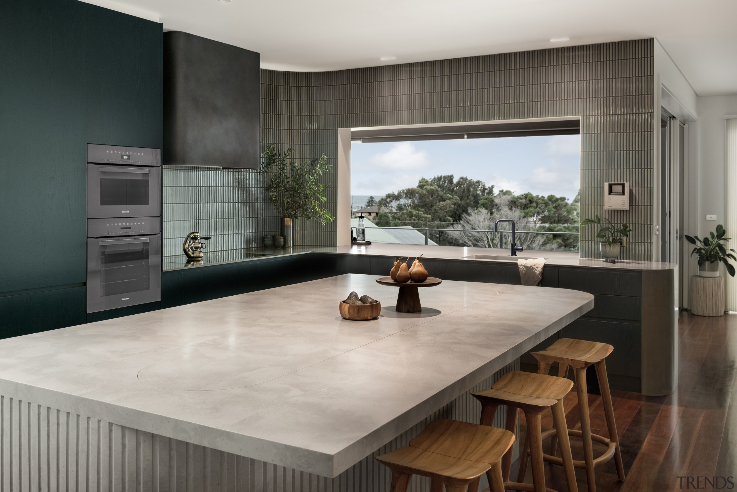 The kitchen's tones, stools included, connect with the 