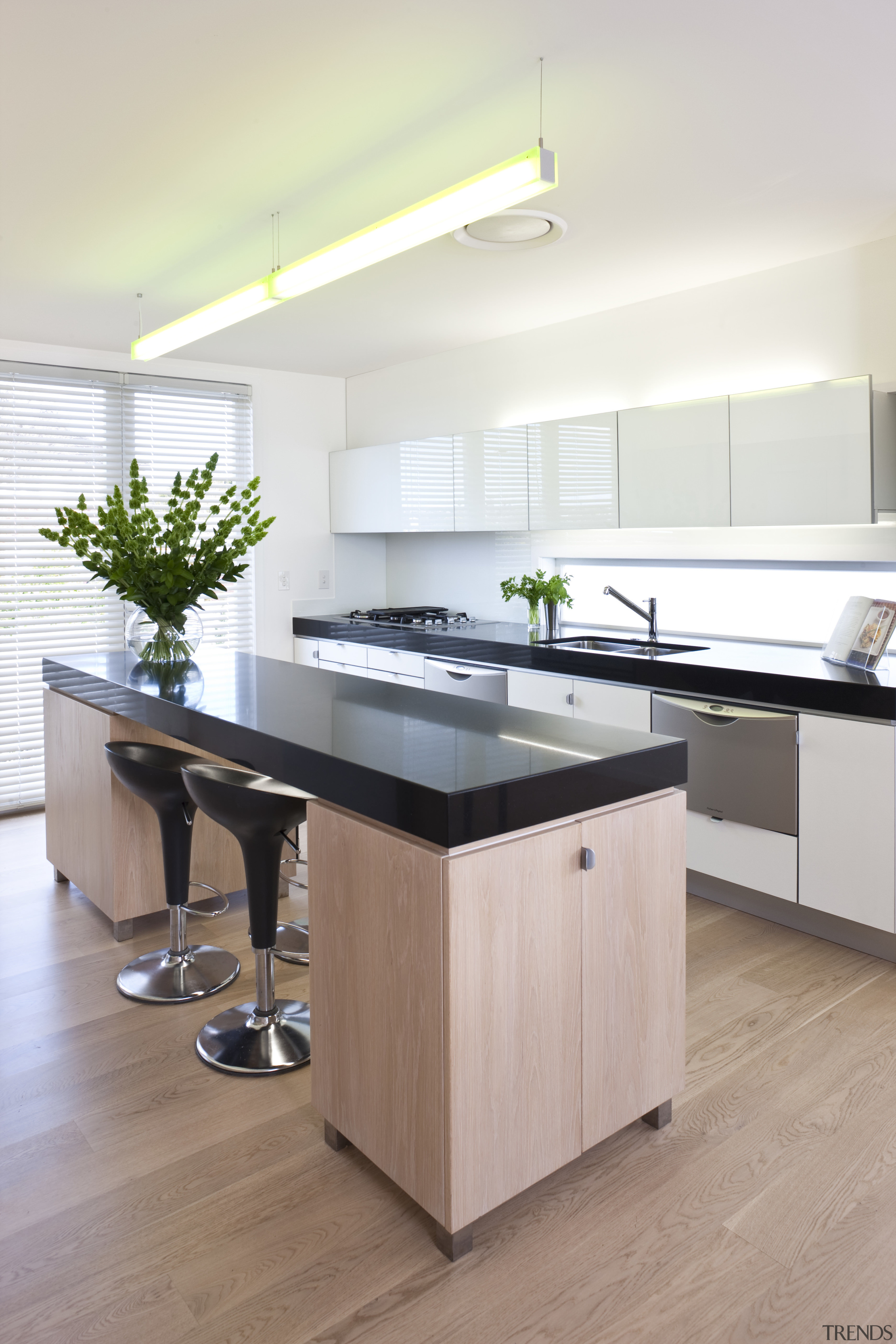 The kitchen features white stained oak cabinetry, Silestone countertop, floor, furniture, hardwood, interior design, kitchen, product design, table, gray, white