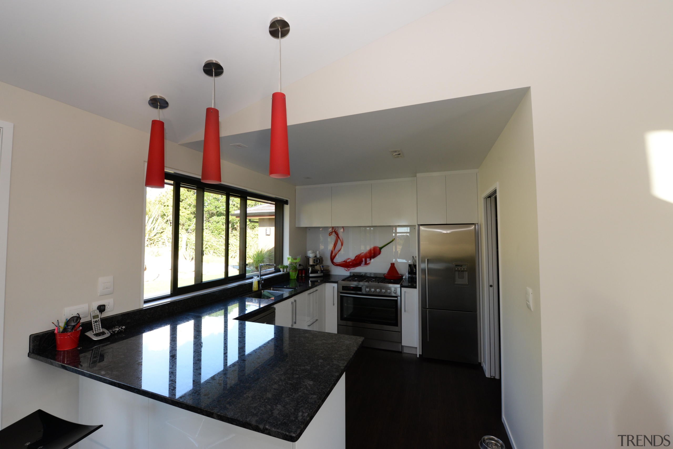 Kitchen design features red hot chilli splash back. house, interior design, property, real estate, gray