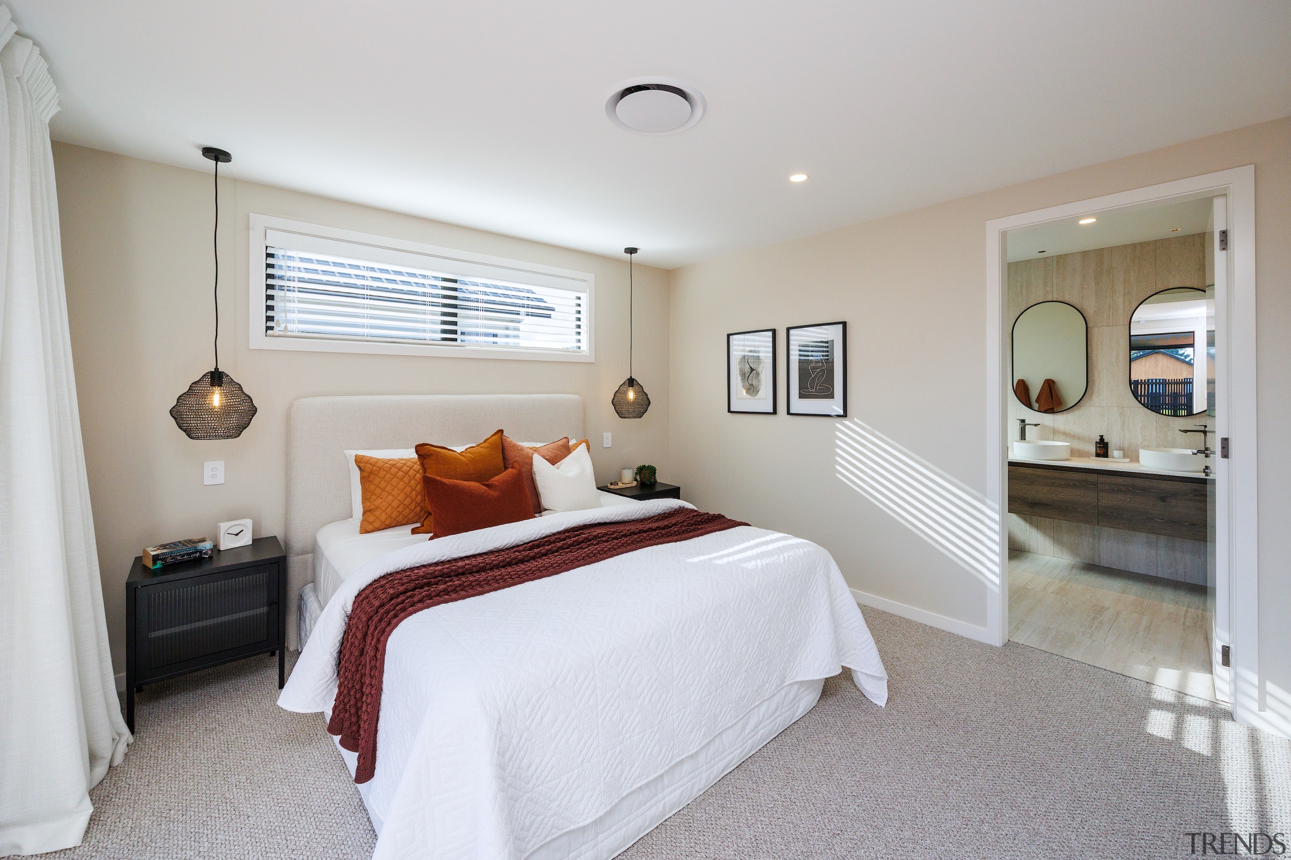 Carpeted master bedroom with diaphanous drapes. 