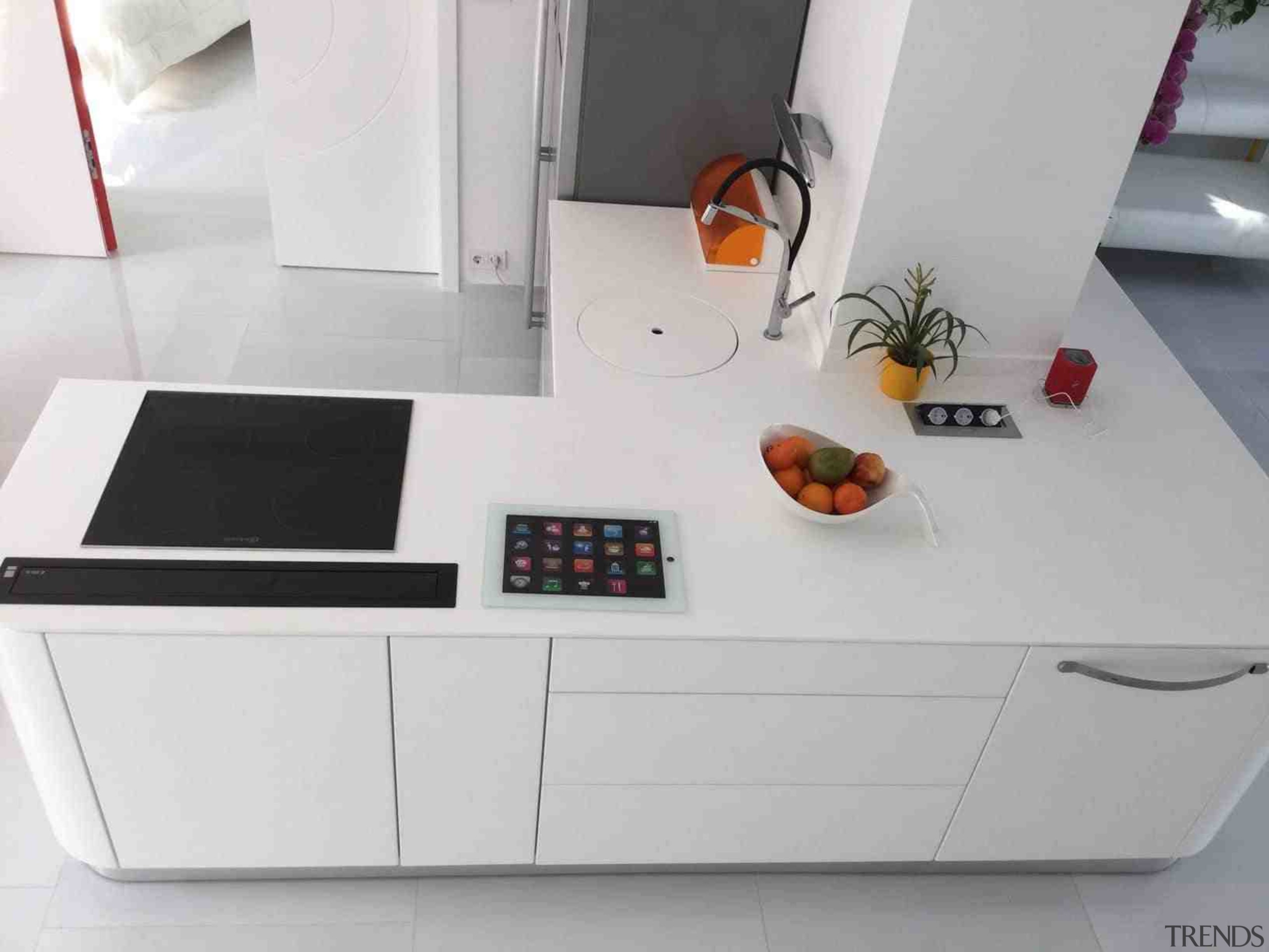 Kitchen work area in colourful Budapest apartment by countertop, furniture, kitchen, product, table, gray