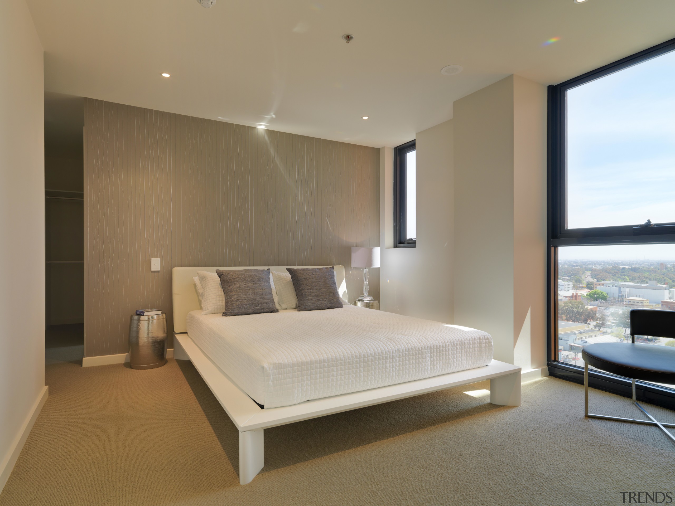 View of the bedroom of an apartment at bed frame, bedroom, ceiling, floor, interior design, mattress, real estate, room, suite, brown, gray