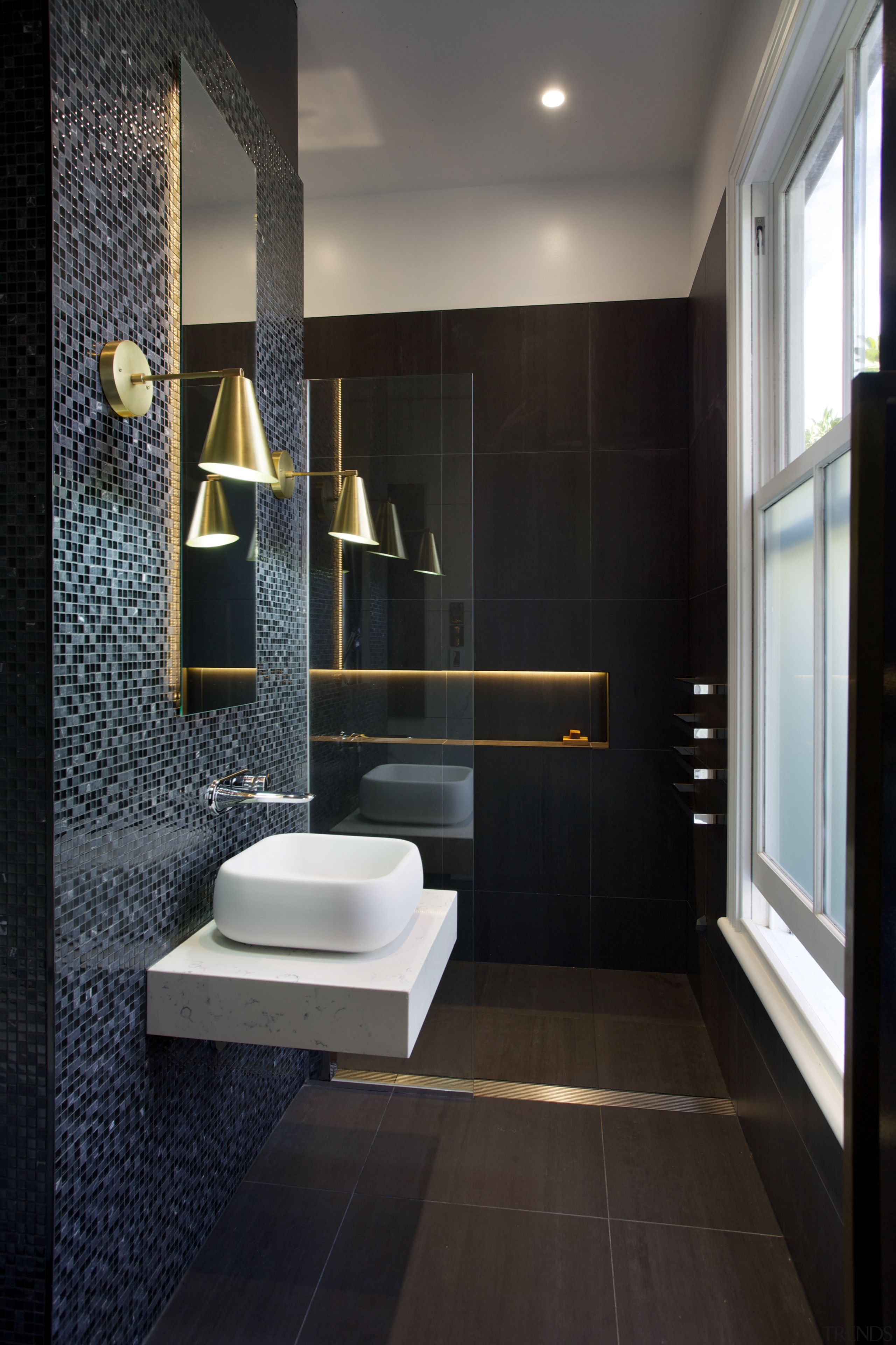 LED lights tucked behind the vanity mirror and architecture, bathroom, floor, flooring, home, interior design, plumbing fixture, room, tile, toilet, wall, black, gray