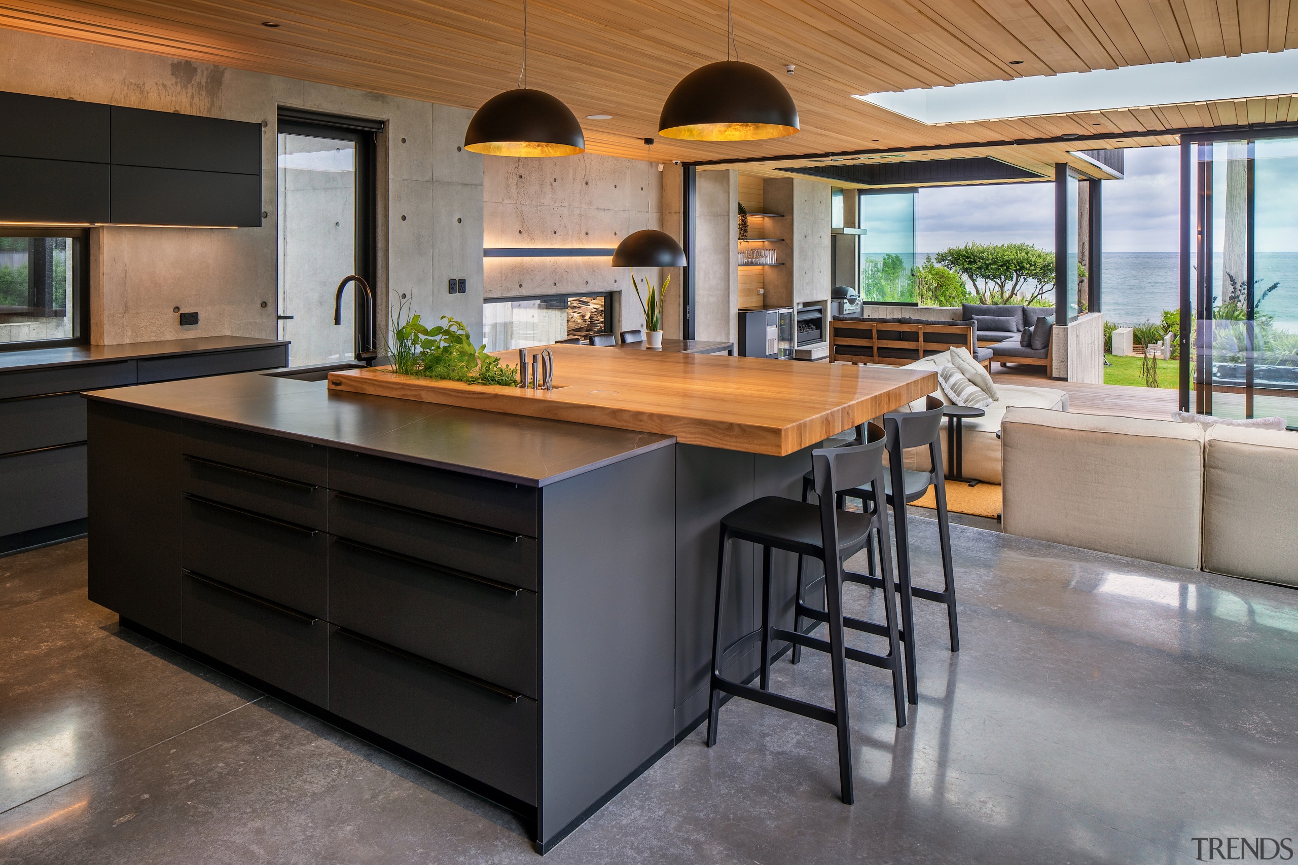 The timber benchtop overhangs on two sides to 