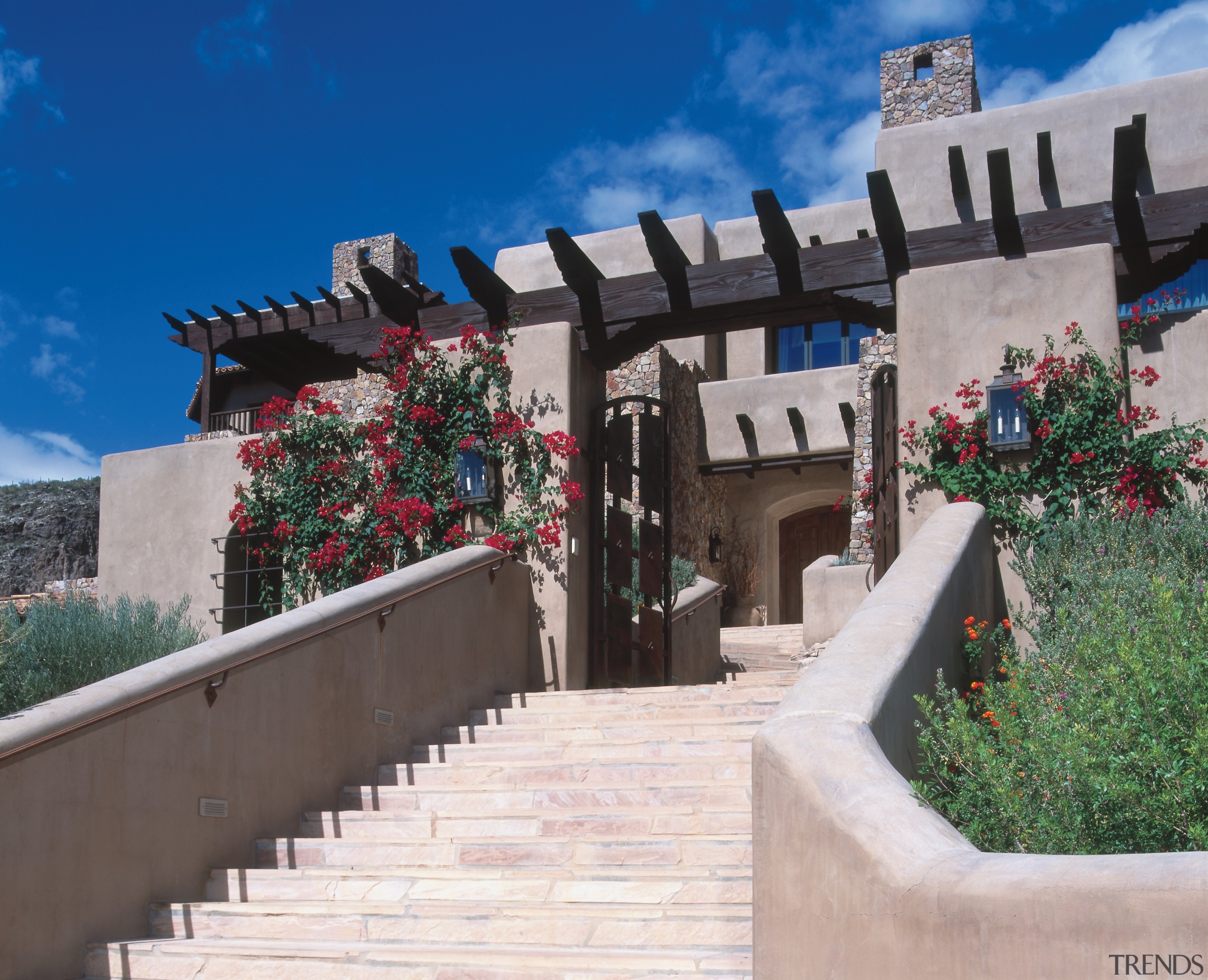 An exterior view of this Tuscan desert home, outdoor structure, property, roof, sky, gray