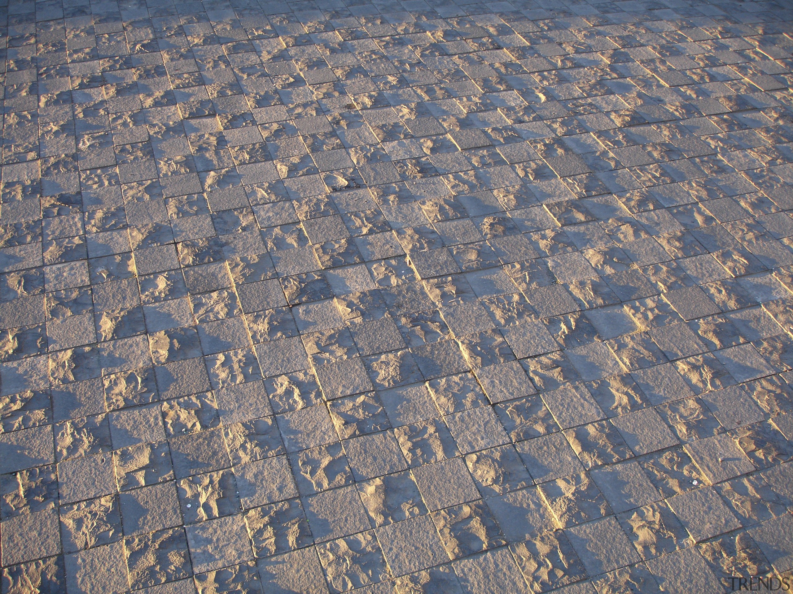 Closeup of patterned paving. - Closeup of patterned aerial photography, cobblestone, geology, material, road surface, sand, sky, soil, texture, gray