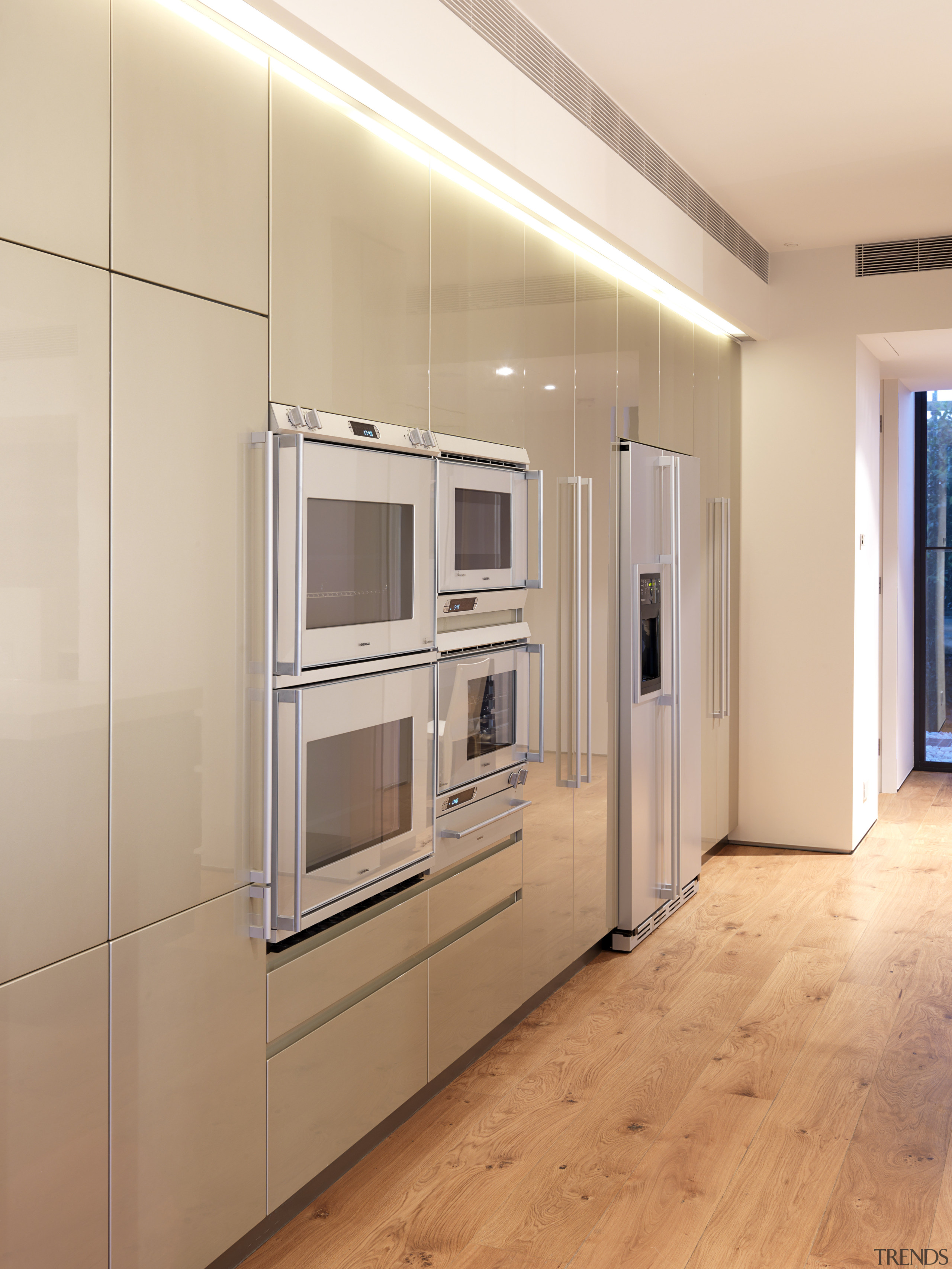 View of kitchen which features a kitchen island cabinetry, floor, flooring, home appliance, interior design, kitchen, real estate, wall, orange