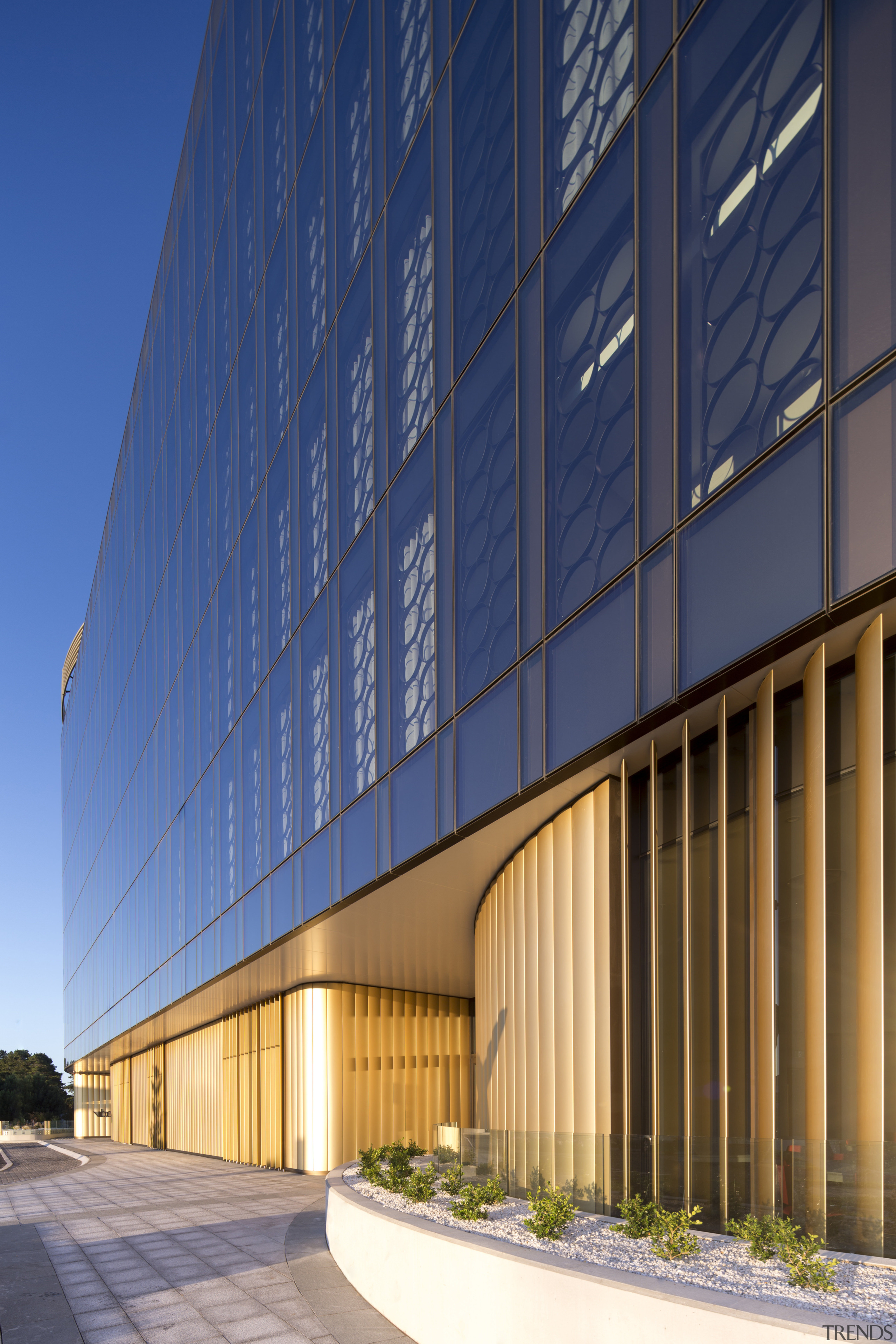 Gold-coloured louvres at ground level on the exterior architecture, building, commercial building, condominium, convention center, corporate headquarters, daylighting, daytime, facade, headquarters, line, metropolitan area, mixed use, real estate, residential area, sky, structure, blue