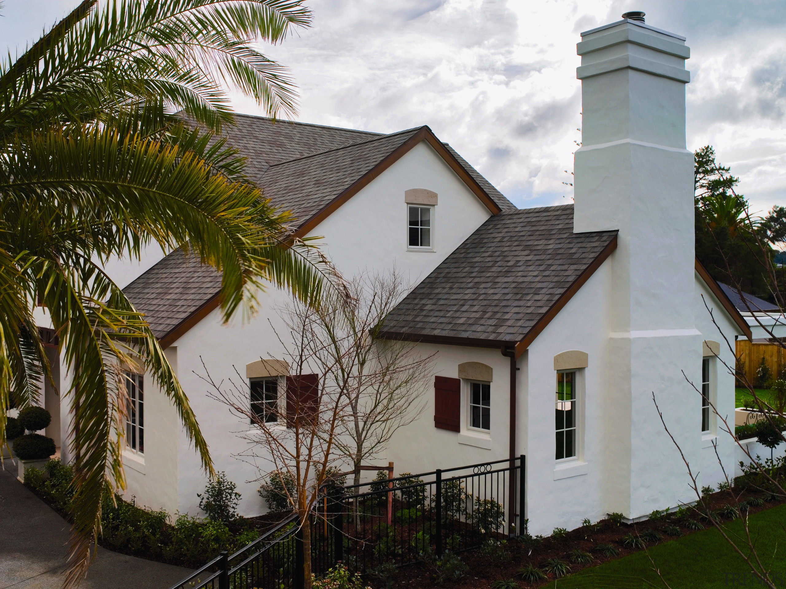 Large cream masonry home with steeply pitched roof building, cottage, facade, home, house, property, real estate, roof, gray