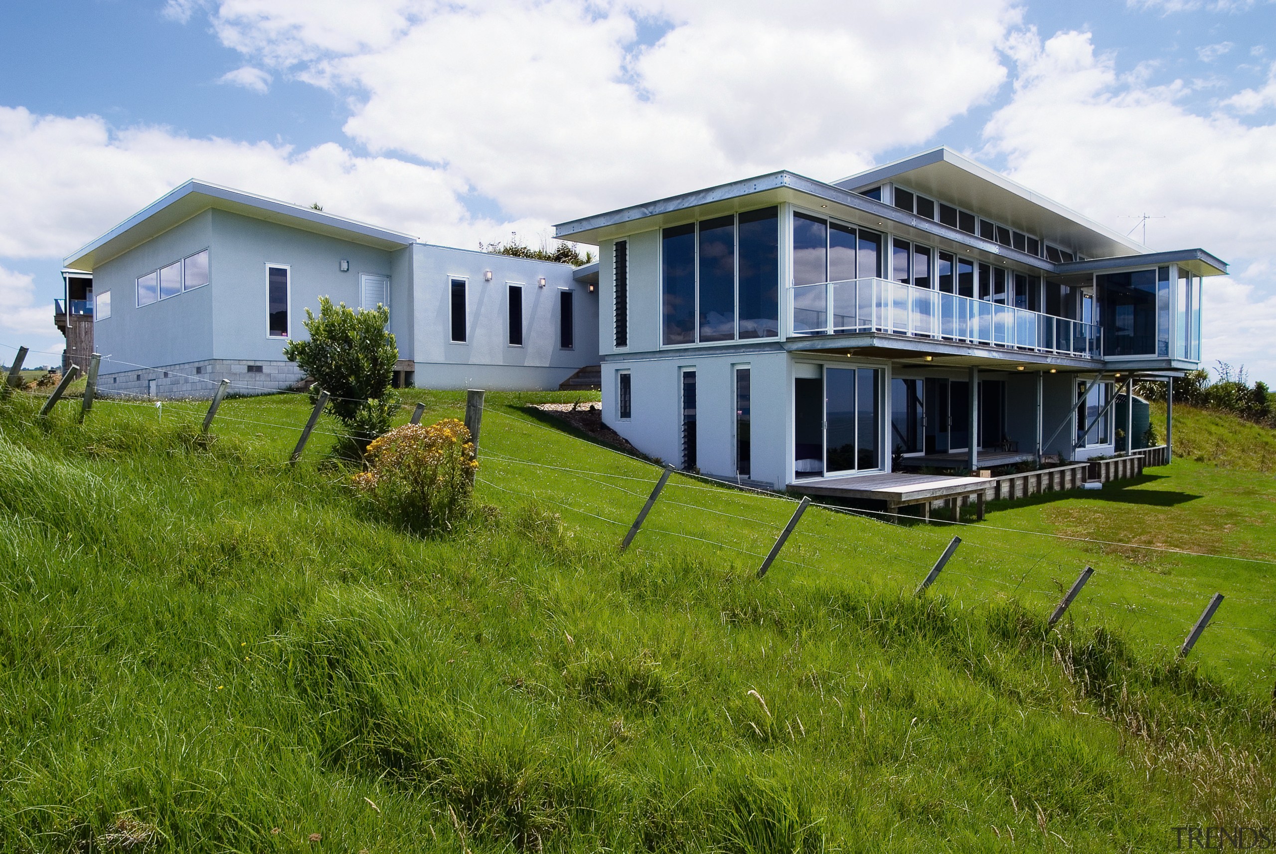 A view of a home by Creative Architeture. cottage, estate, farmhouse, grass, home, house, land lot, landscape, property, real estate, residential area, rural area, sky, brown, white