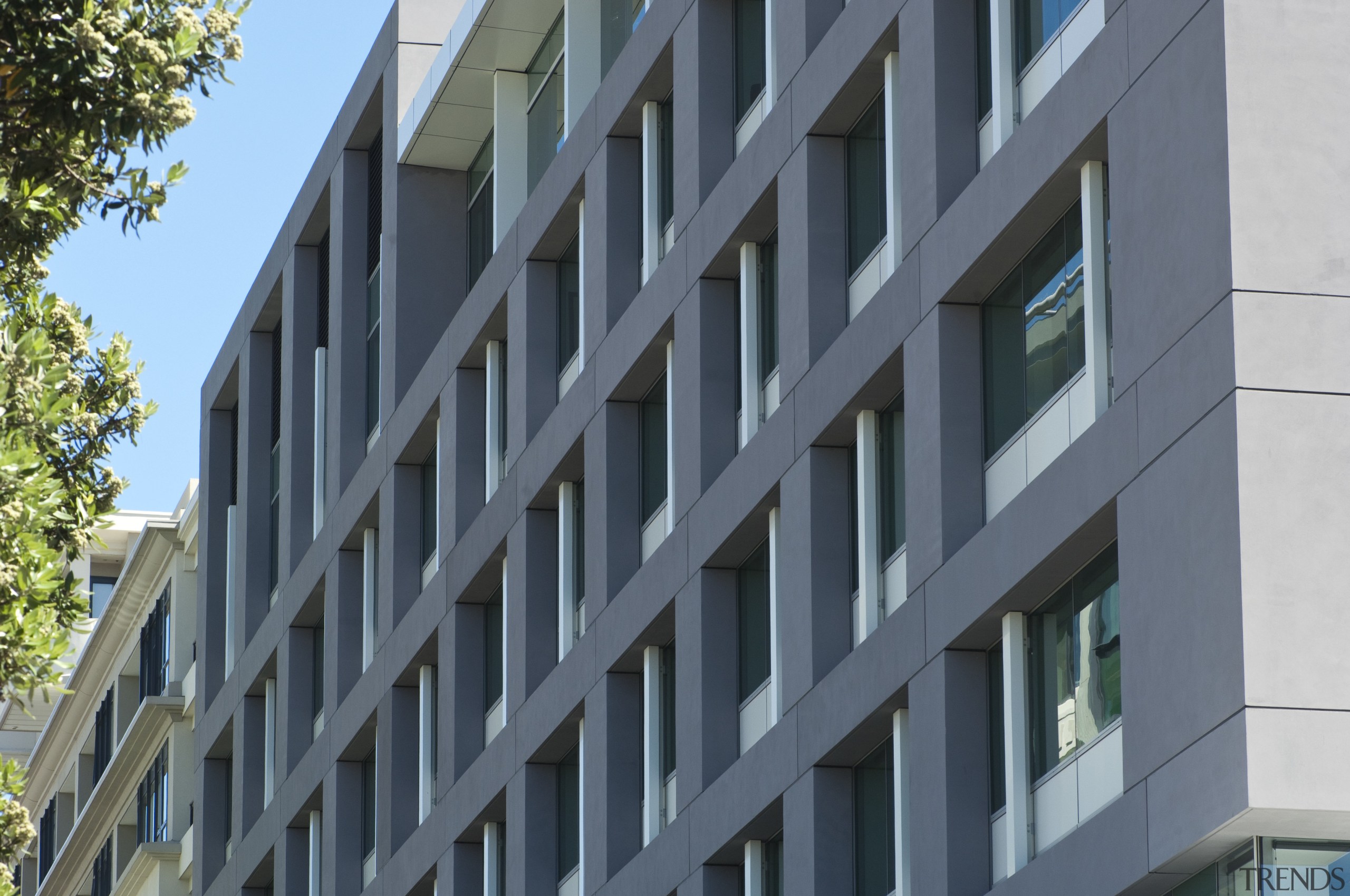 View of the exterior of the Vogel Center apartment, architecture, brutalist architecture, building, commercial building, condominium, corporate headquarters, daylighting, daytime, elevation, facade, headquarters, house, metropolis, metropolitan area, mixed use, neighbourhood, property, real estate, residential area, tower block, window, gray, black