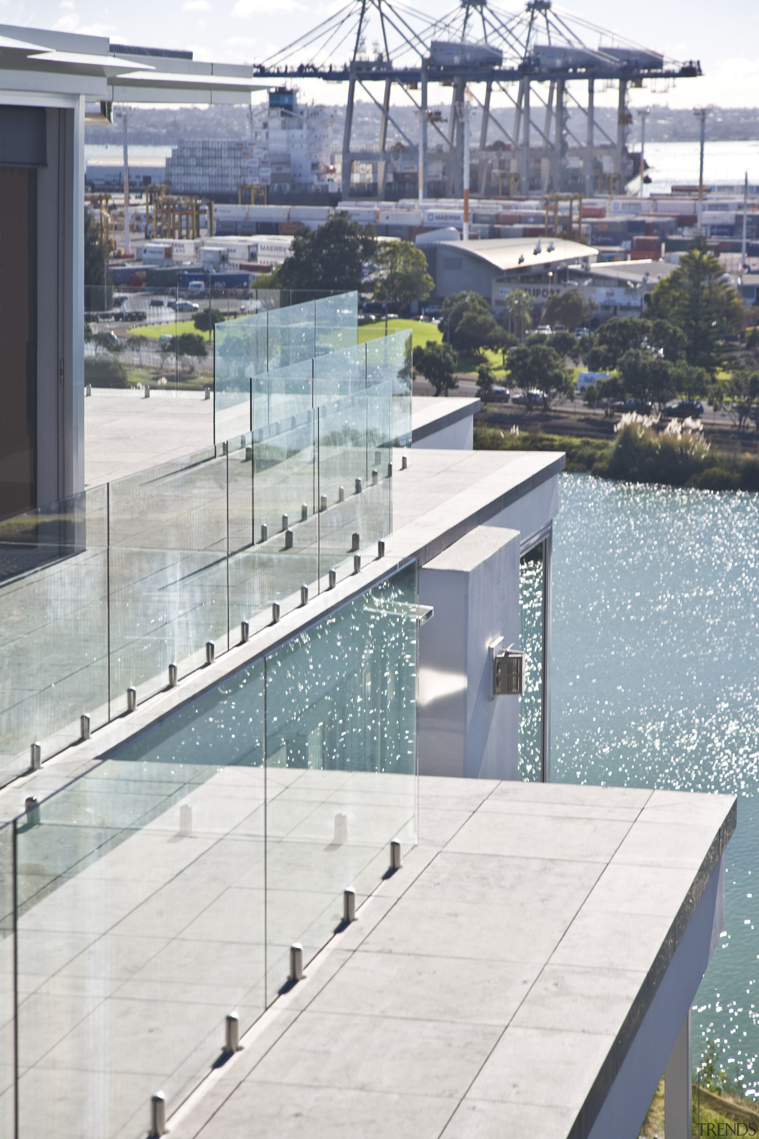 View of apartment balconies with glass balustrades. condominium, swimming pool, water, gray, white