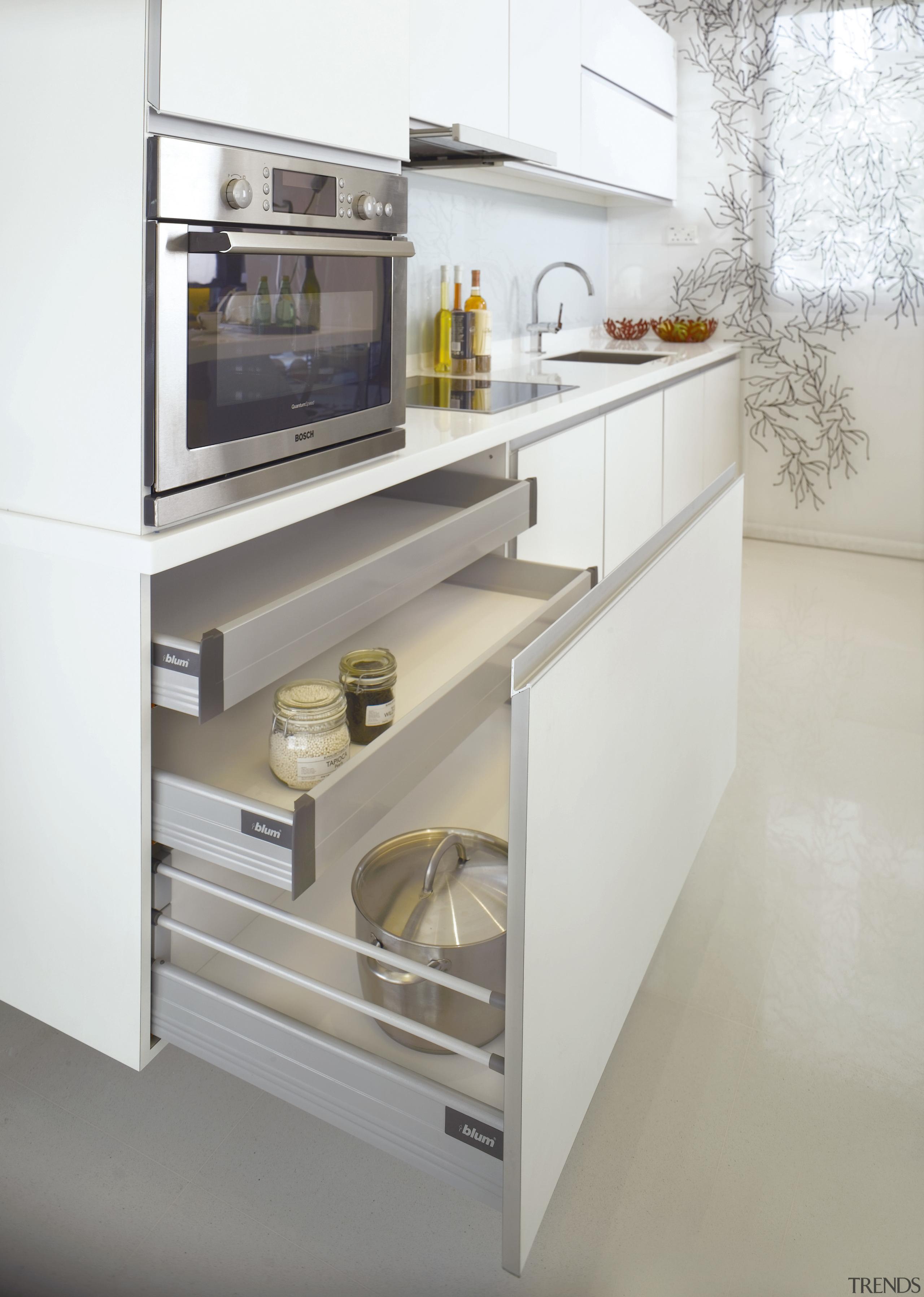 The sleek cabinetry features a white laminate with countertop, drawer, furniture, home appliance, kitchen, kitchen appliance, kitchen stove, major appliance, product, product design, gray, white