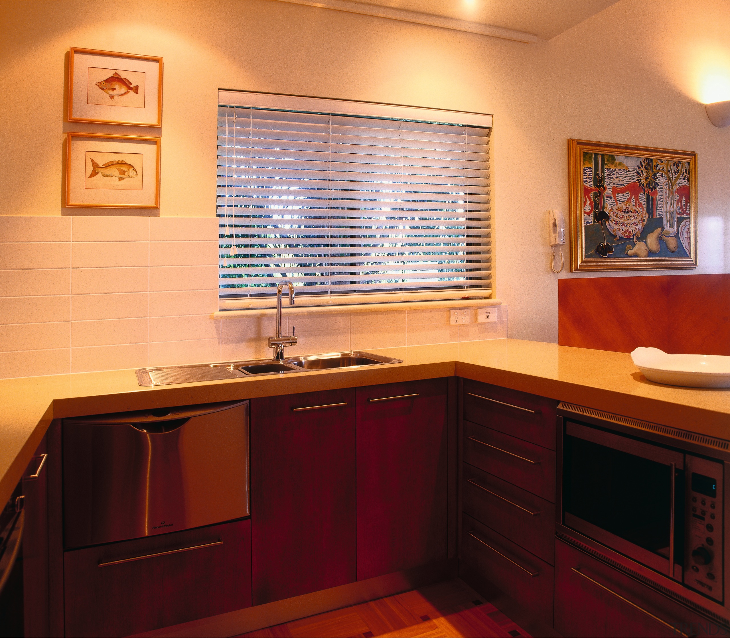 View of the kitchen featuring parquetry T&amp;G flooring, cabinetry, countertop, flooring, hardwood, home, interior design, kitchen, real estate, room, under cabinet lighting, wood, orange, red