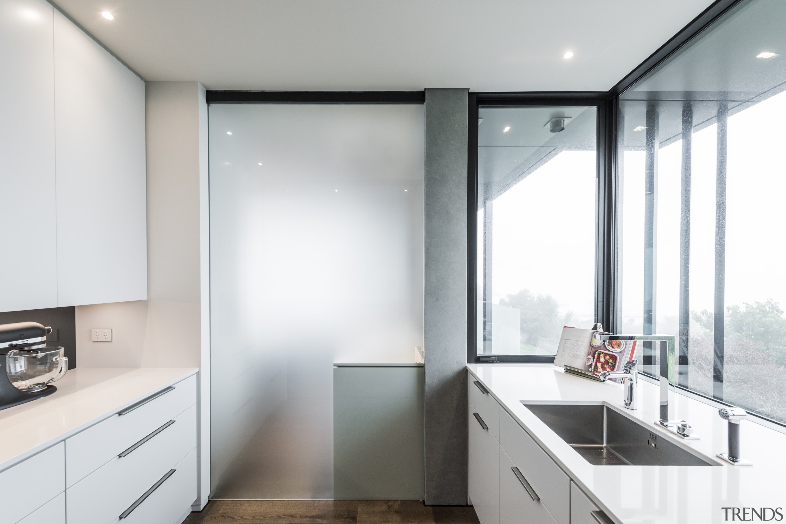 ​​​​​​​In this kitchen, a frosted glass door can architecture, countertop, house, interior design, kitchen, real estate, window, white, gray