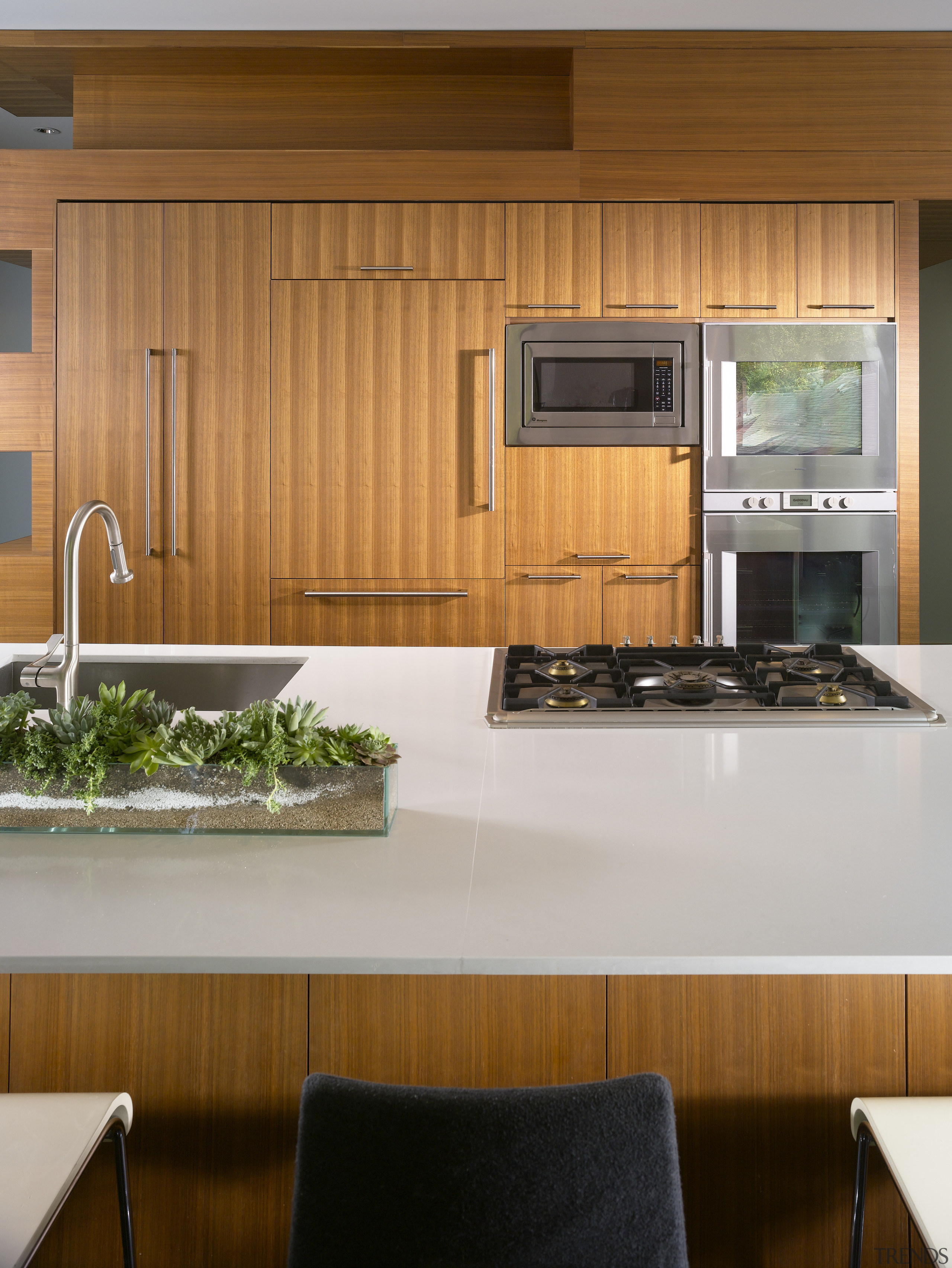 View of kitchen with wooden cabinetry and white cabinetry, countertop, interior design, kitchen, under cabinet lighting, brown, gray