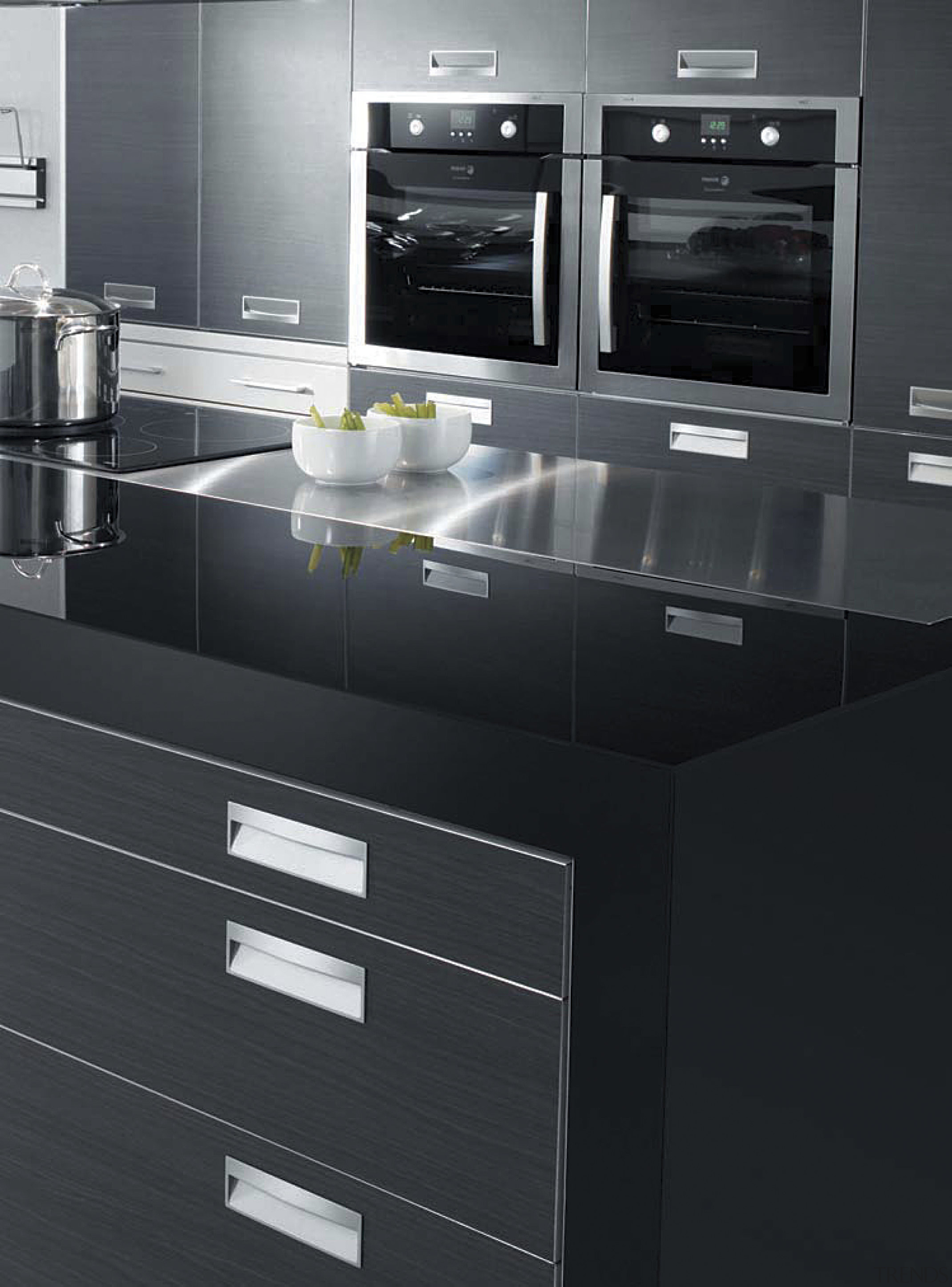 With a fully integrated kitchen design, appliances are countertop, floor, furniture, home appliance, kitchen, kitchen appliance, kitchen stove, product, product design, black