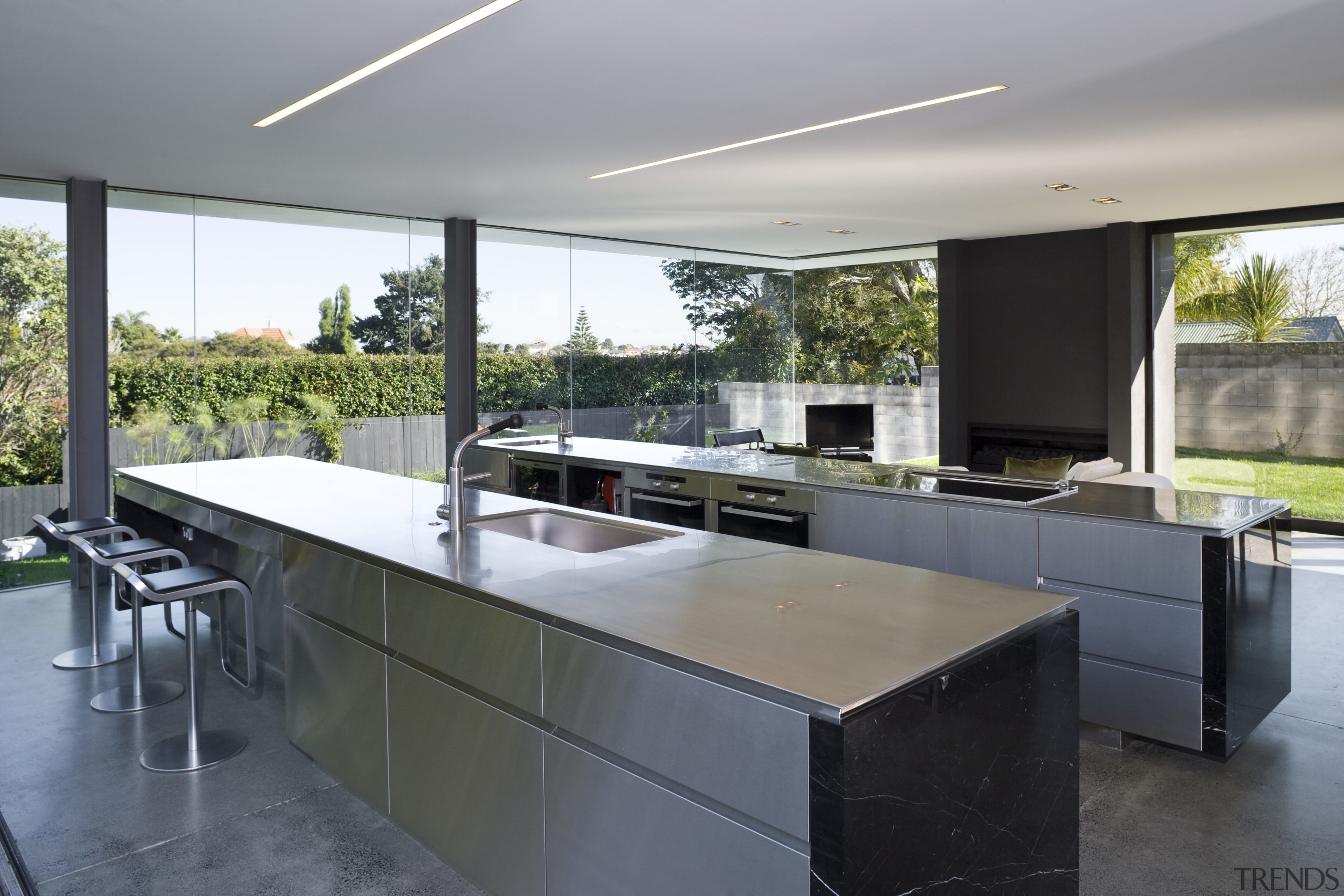 View of open-plan kitchen featuring polished concrete flooring, architecture, countertop, house, interior design, kitchen, real estate, gray, black