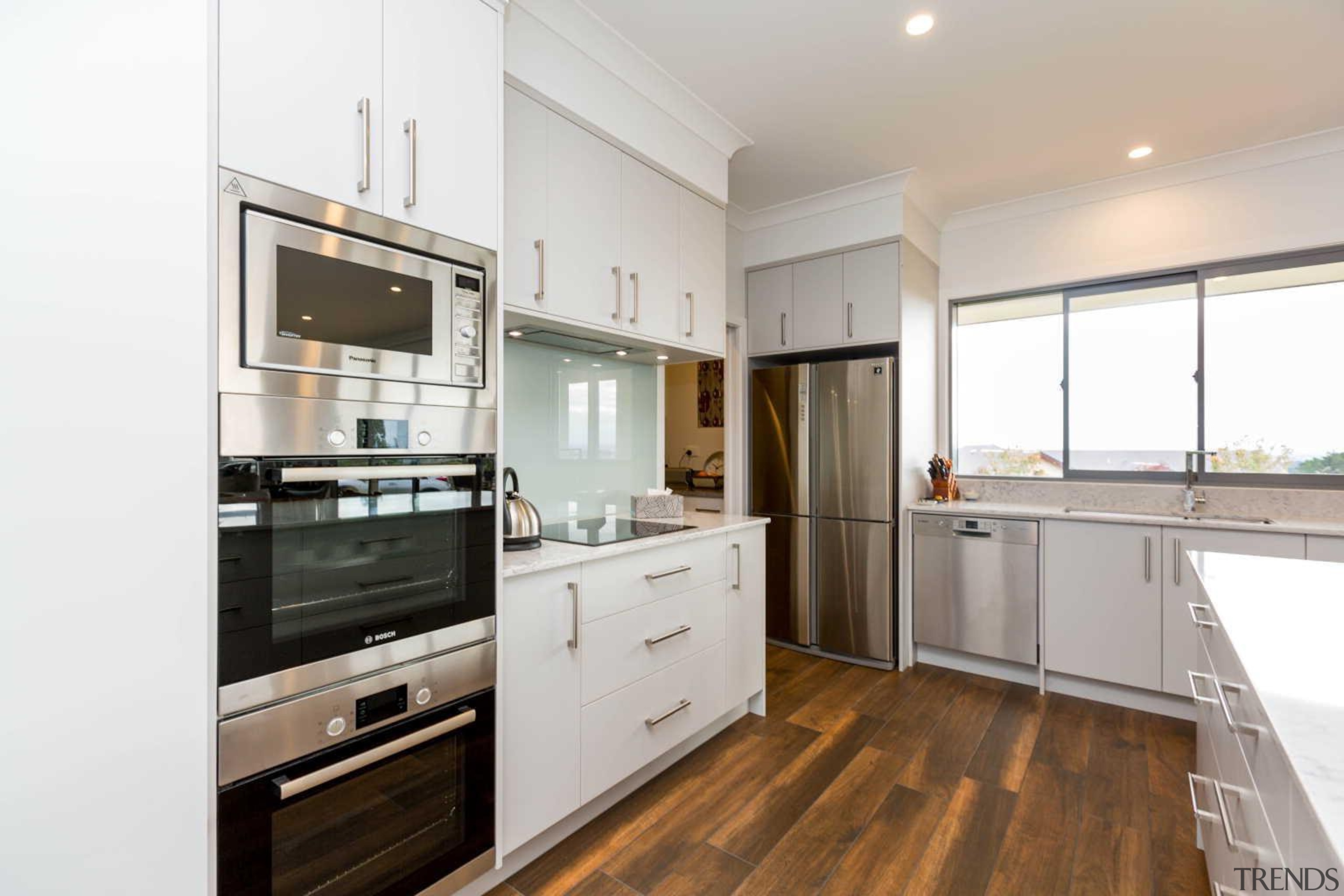 In the kitchen of this new house designed countertop, cuisine classique, floor, home appliance, interior design, kitchen, property, real estate, room, white