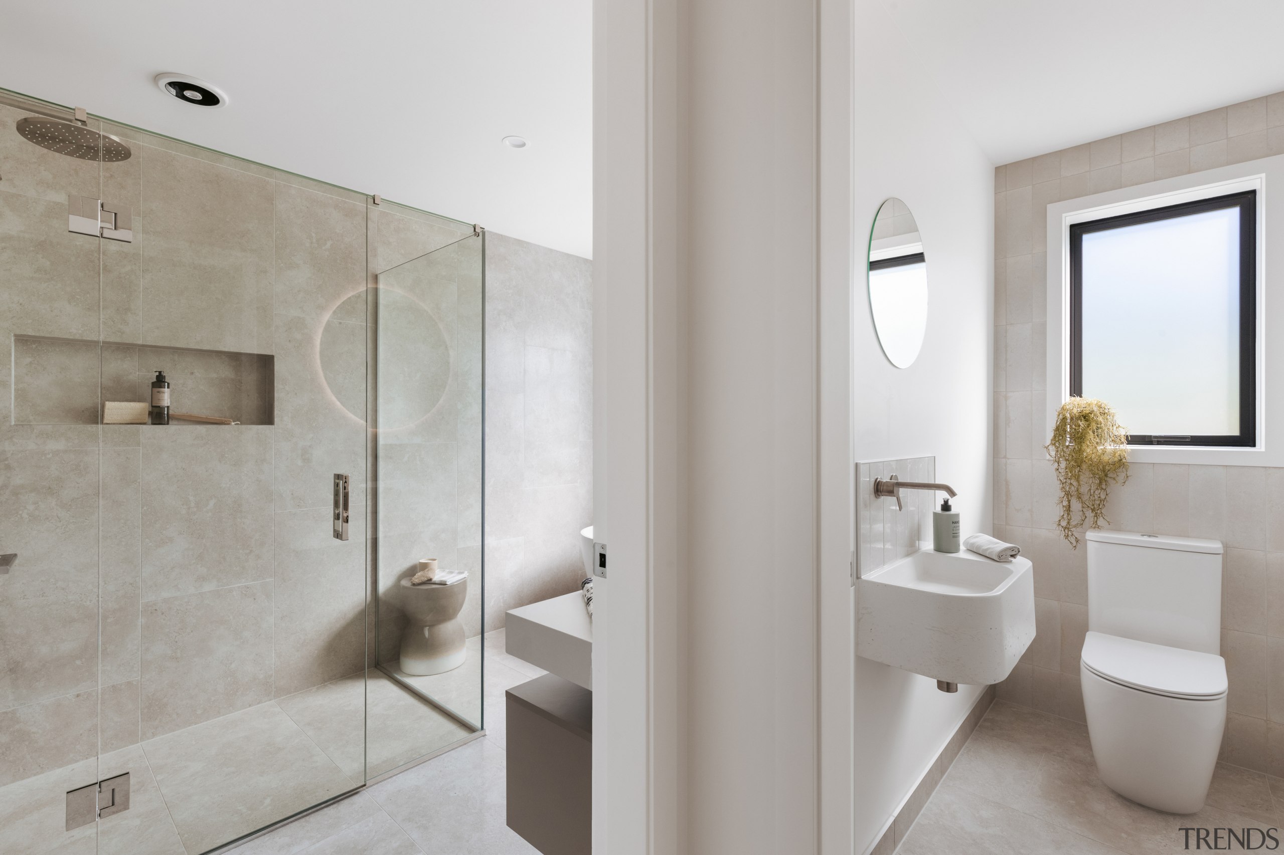 A seperate toilet sits alongside the main bathroom. 