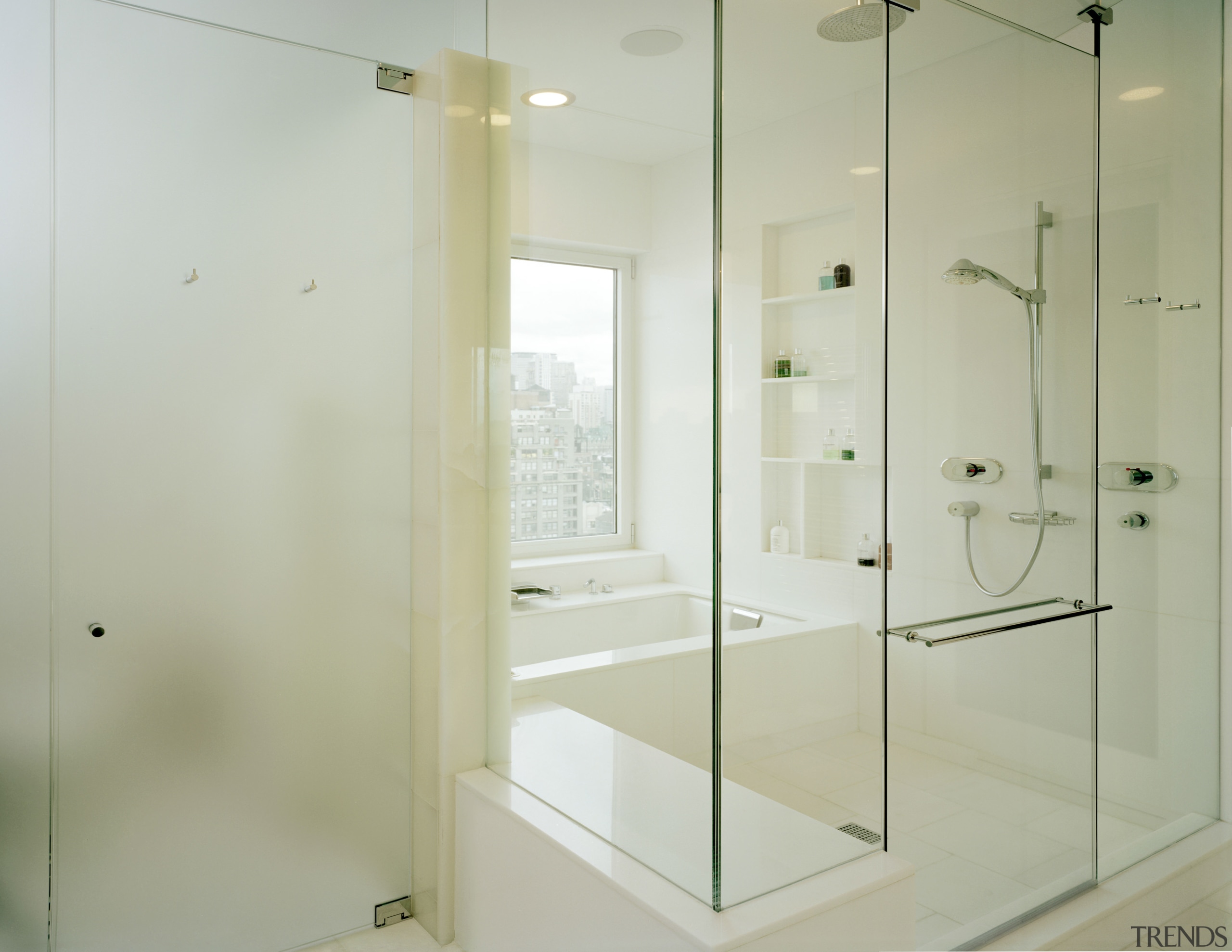 View of the all white bathroom designed to bathroom, floor, glass, interior design, plumbing fixture, shower, shower door, gray