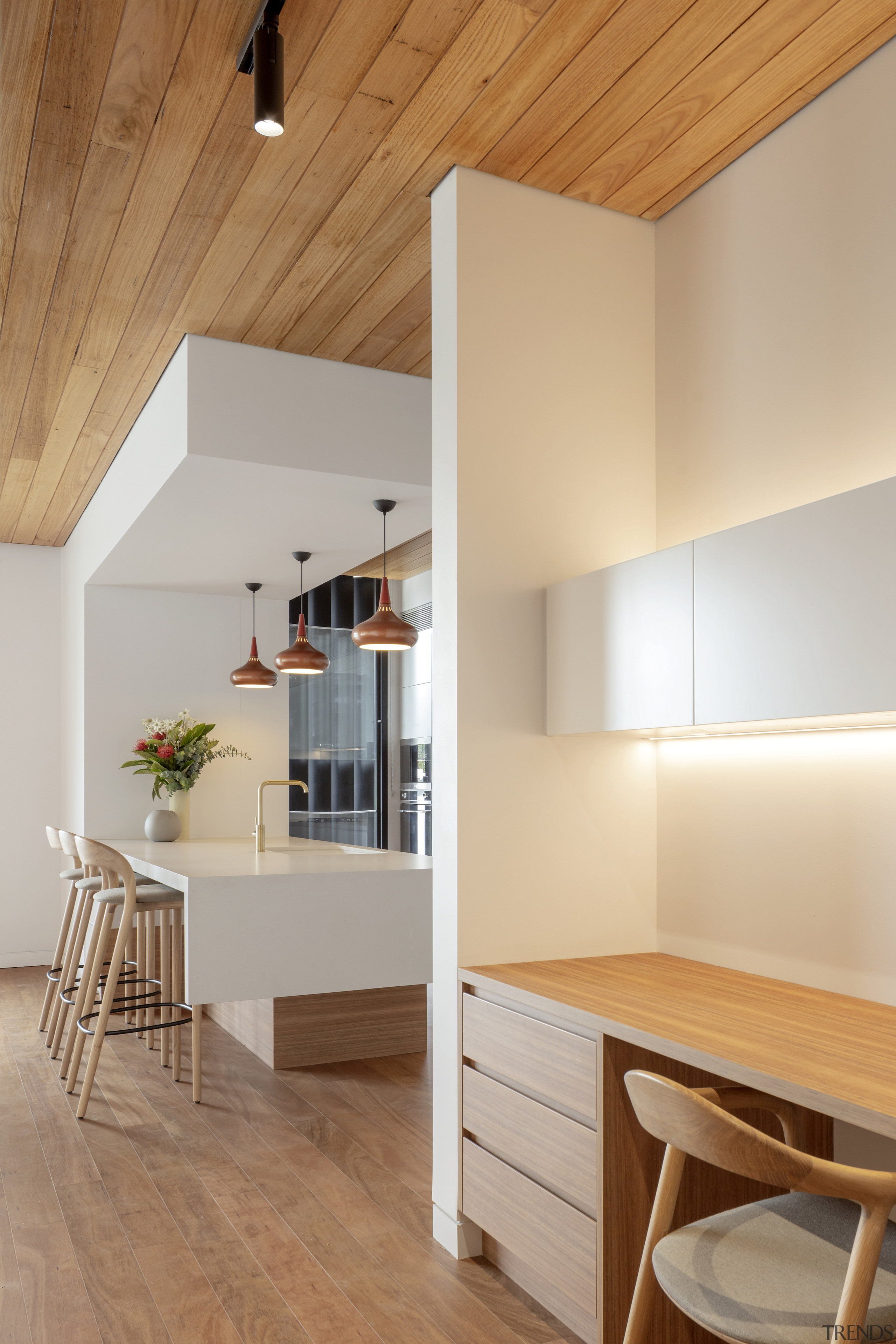 An apartment kitchen with adjacent study nook. 