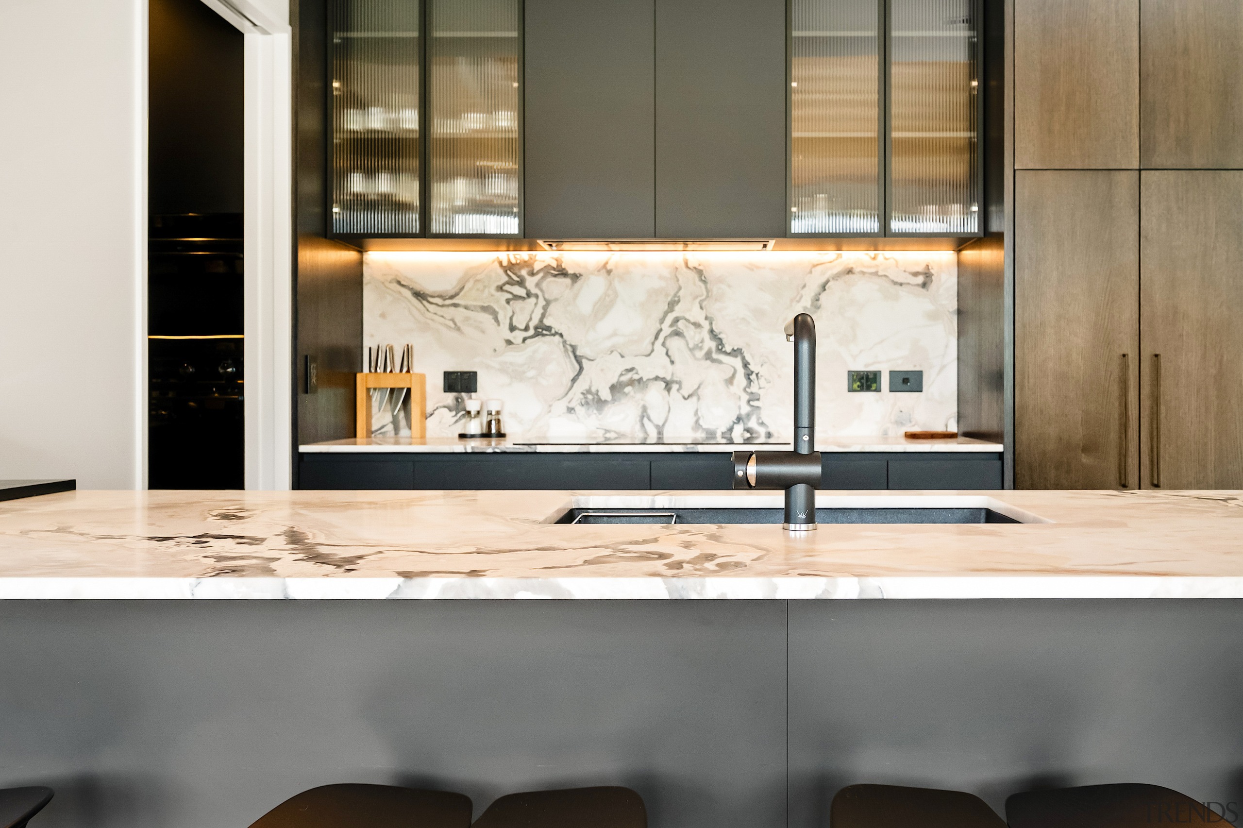 The reeded glass-fronted upper cabinets provide hints as 