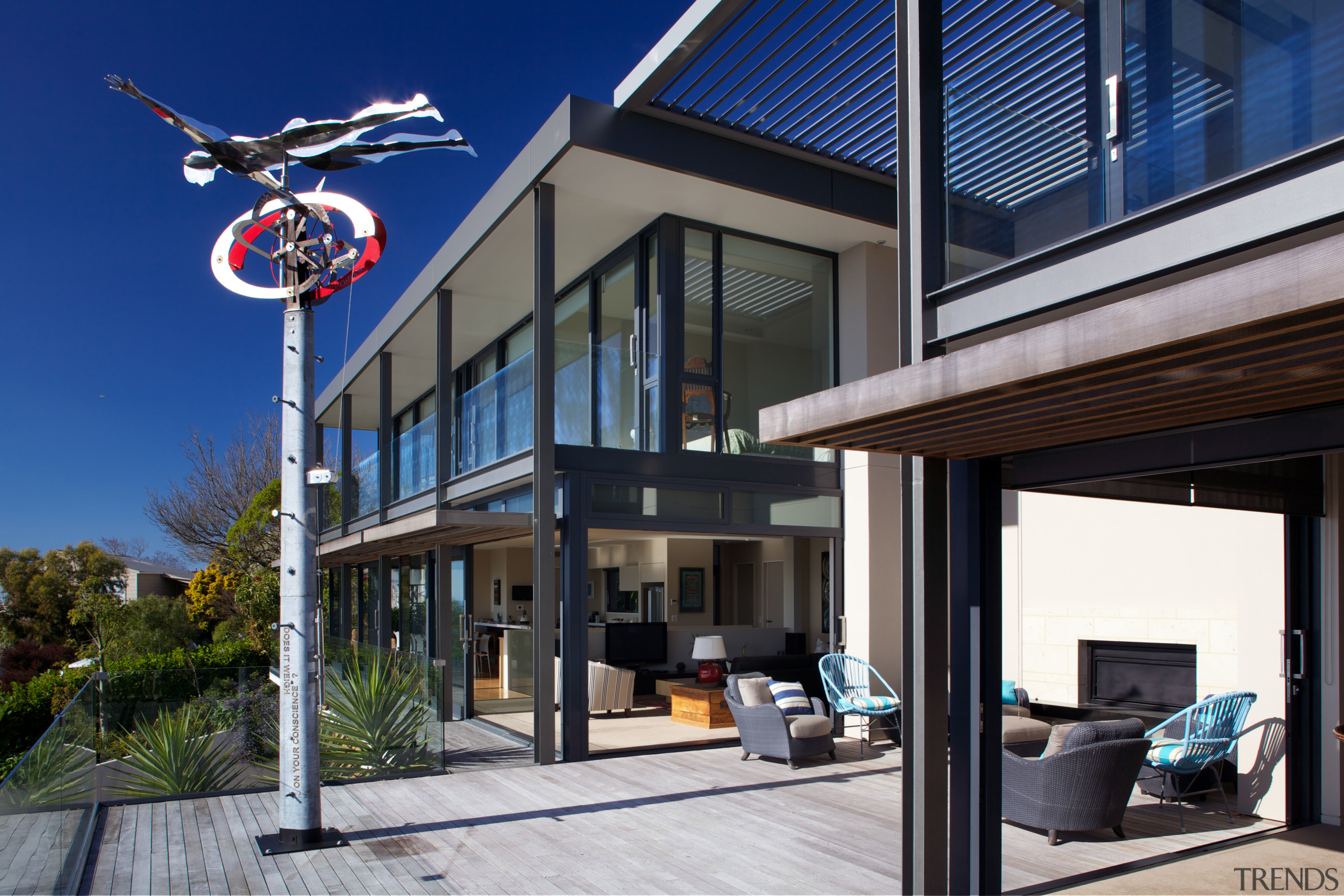 A sculpture by Graham Bennett faces the sea building, home, house, real estate, window, black