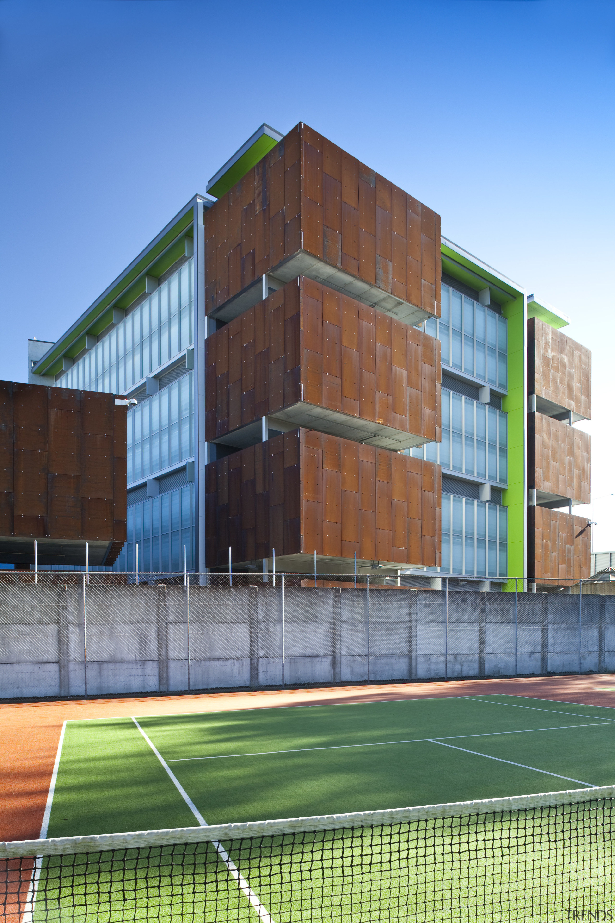 View of the Mt Eden Corrections Facility. - architecture, building, commercial building, corporate headquarters, elevation, facade, grass, headquarters, house, line, net, real estate, residential area, sky, sport venue, structure, teal