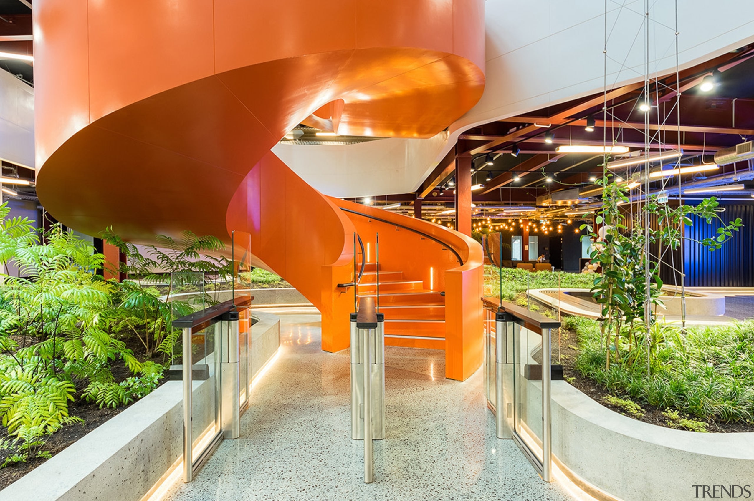 The curling steel staircase provides a vibrant, eye-catching architecture, orange, white