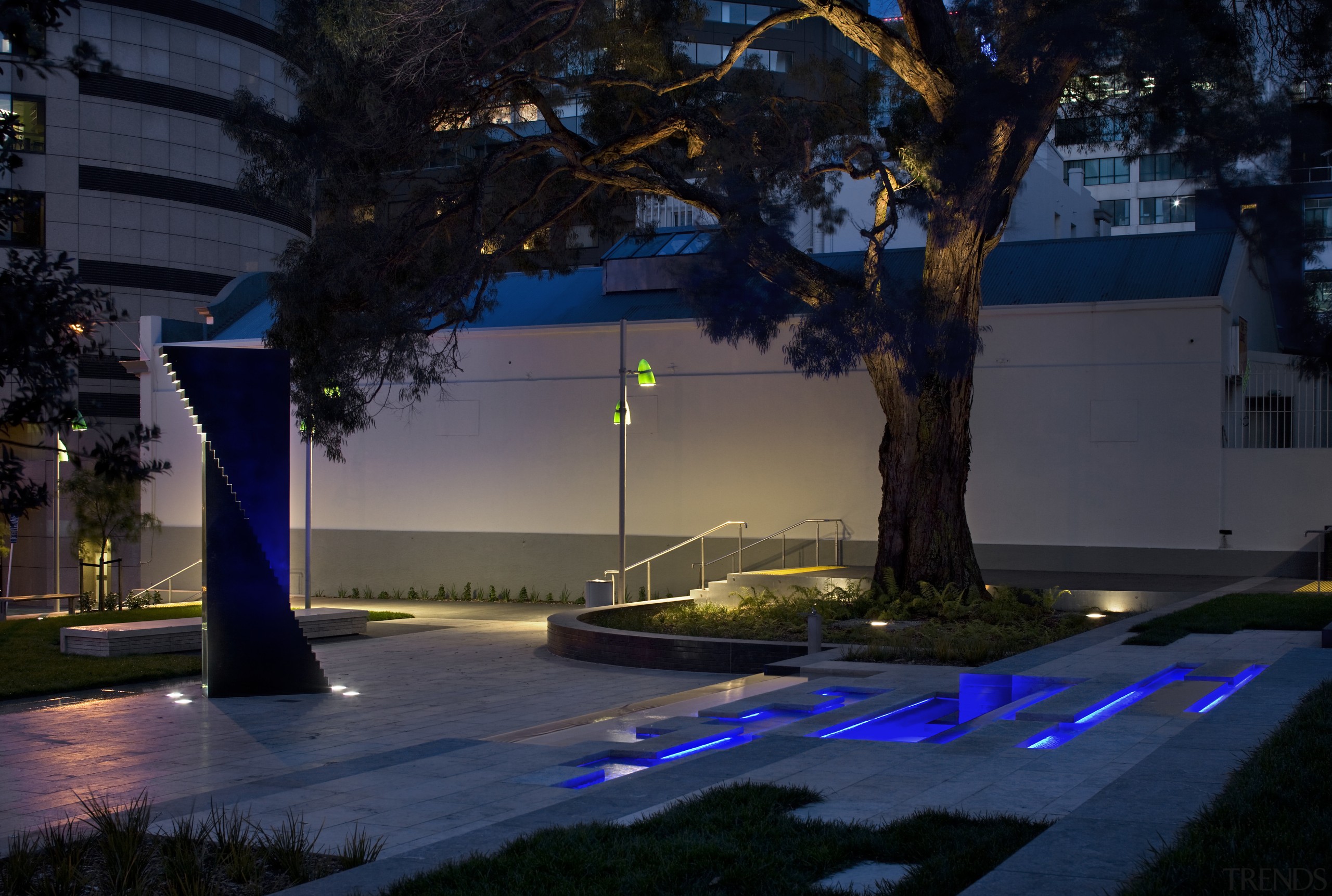 View of the St Patrick's Square where the architecture, city, darkness, evening, landscape lighting, light, lighting, metropolitan area, night, plant, reflection, sky, tree, urban area, water, black