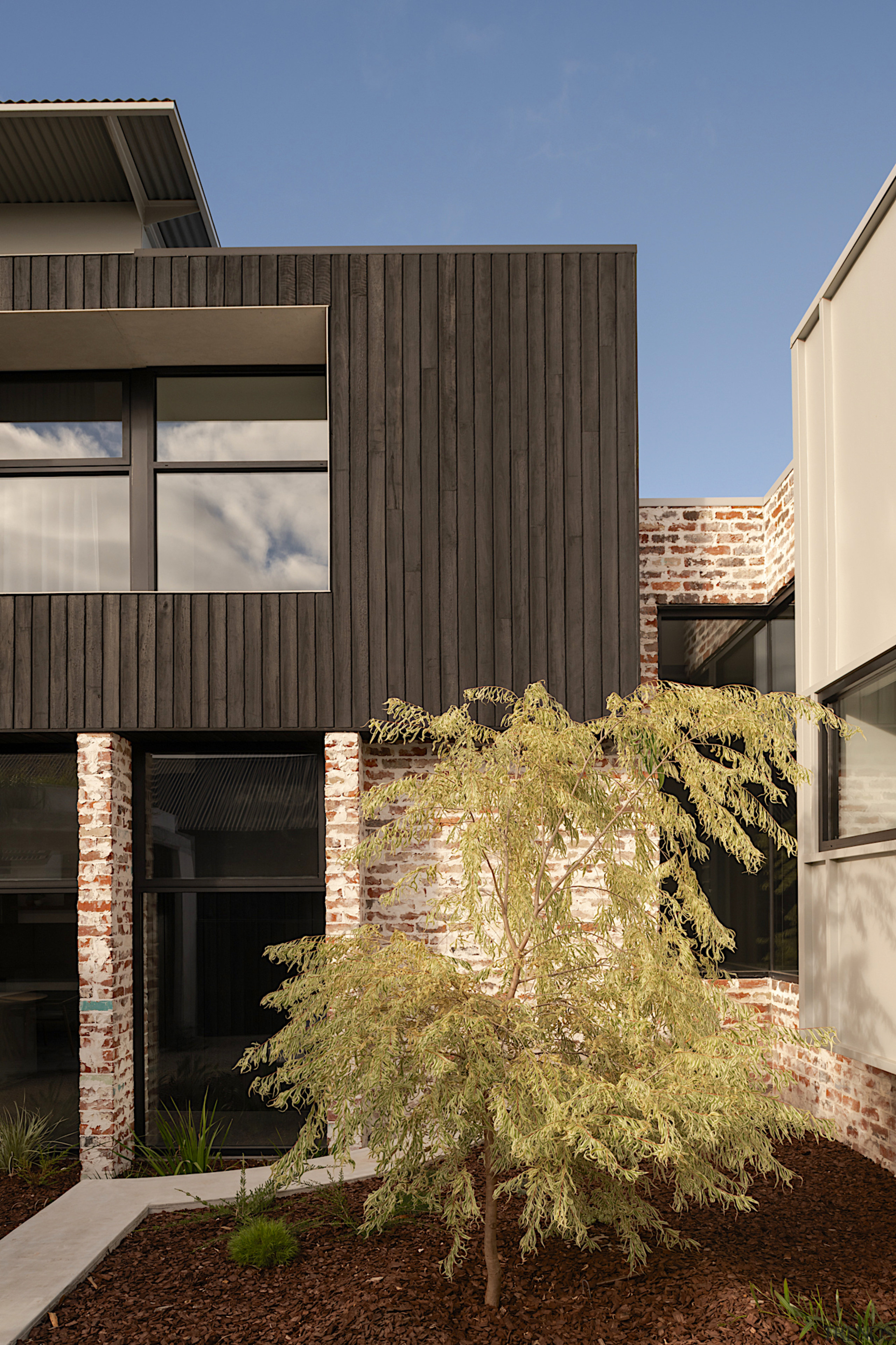 Exterior detail showing the home's various honest, rustic 