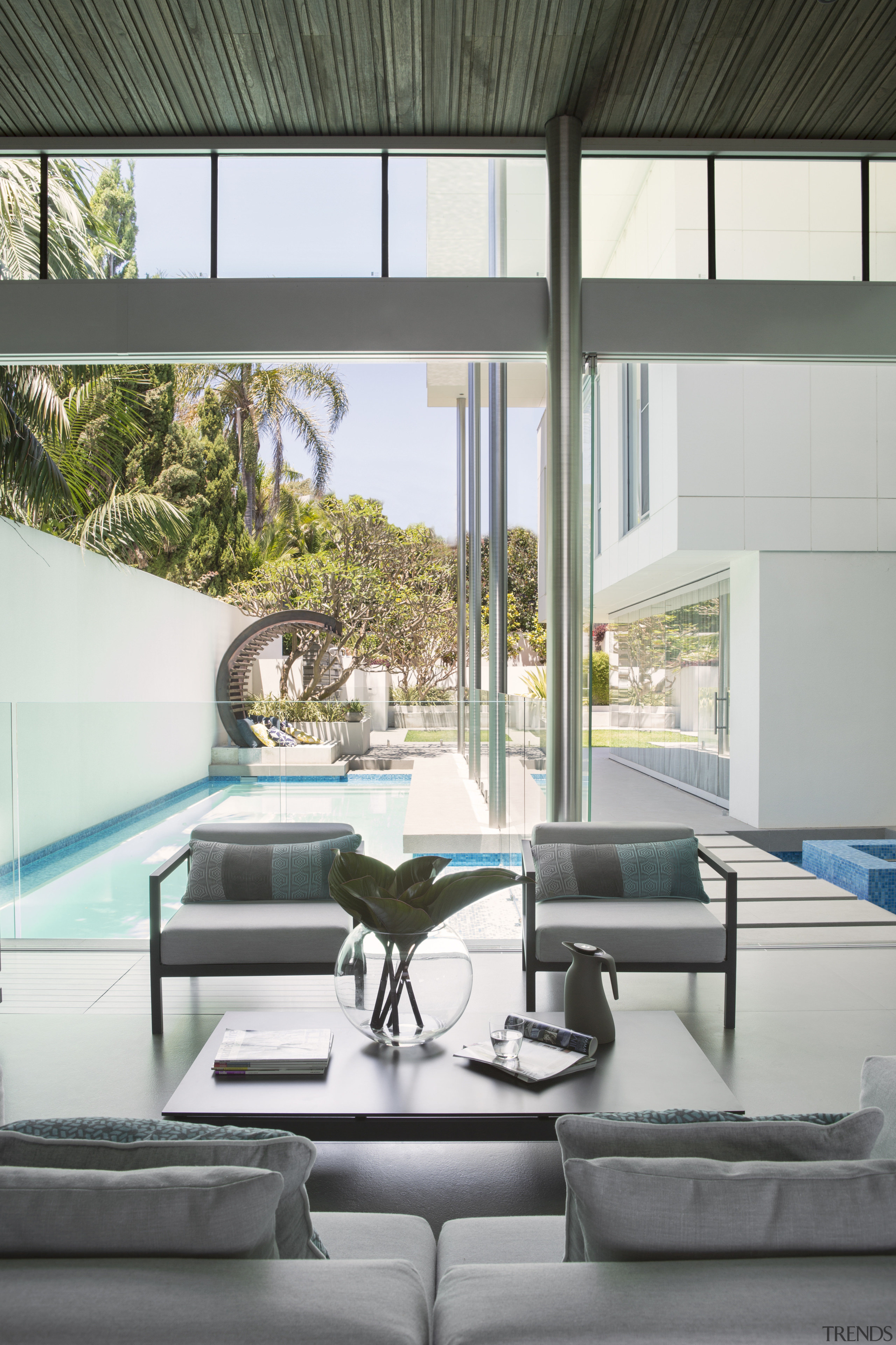 This indoor-outdoor living area overlooks a lane pool architecture, daylighting, furniture, glass, home, house, interior design, living room, table, window, white, gray