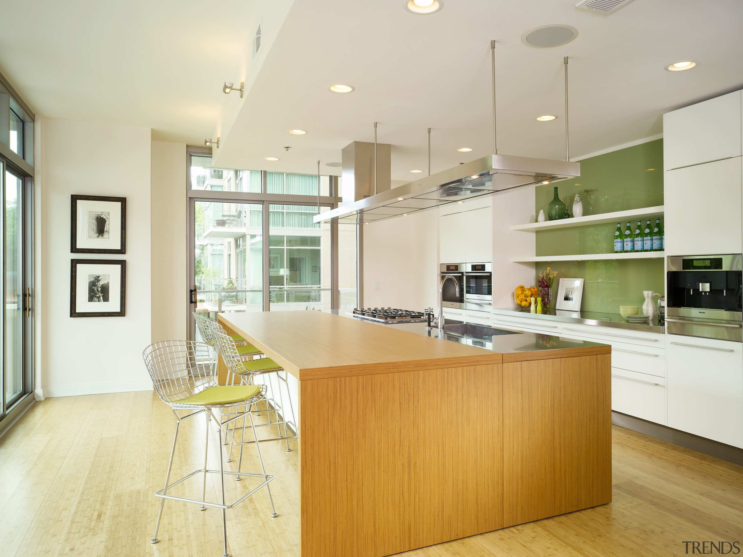 View of a kitchen which features a large cabinetry, ceiling, countertop, floor, hardwood, interior design, kitchen, real estate, room, wood flooring, gray, white