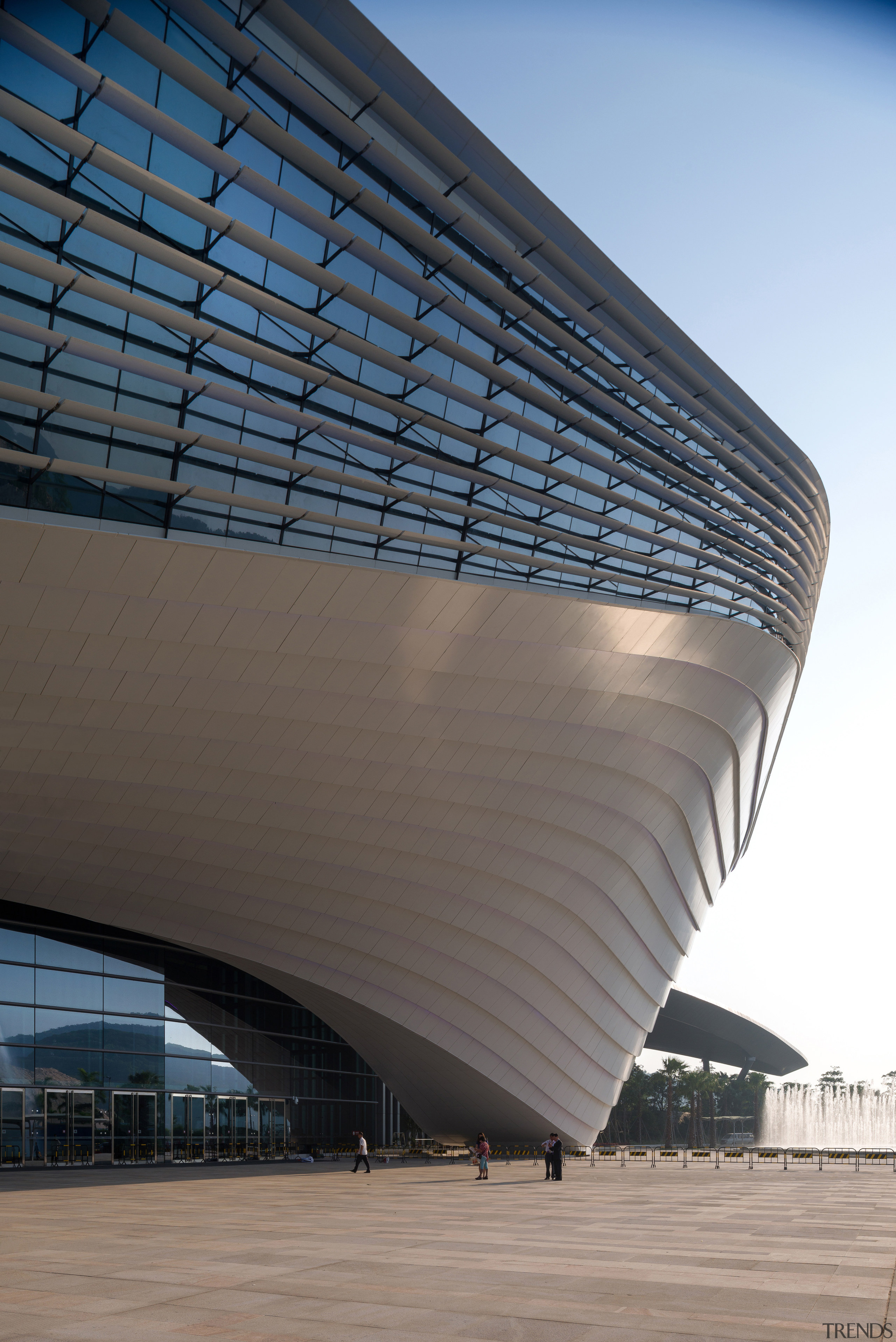 An architectural ribbon winds around the Zhuhai International architecture, building, convention center, corporate headquarters, daylighting, daytime, facade, fixed link, headquarters, landmark, line, metropolitan area, roof, sky, skyscraper, structure, gray