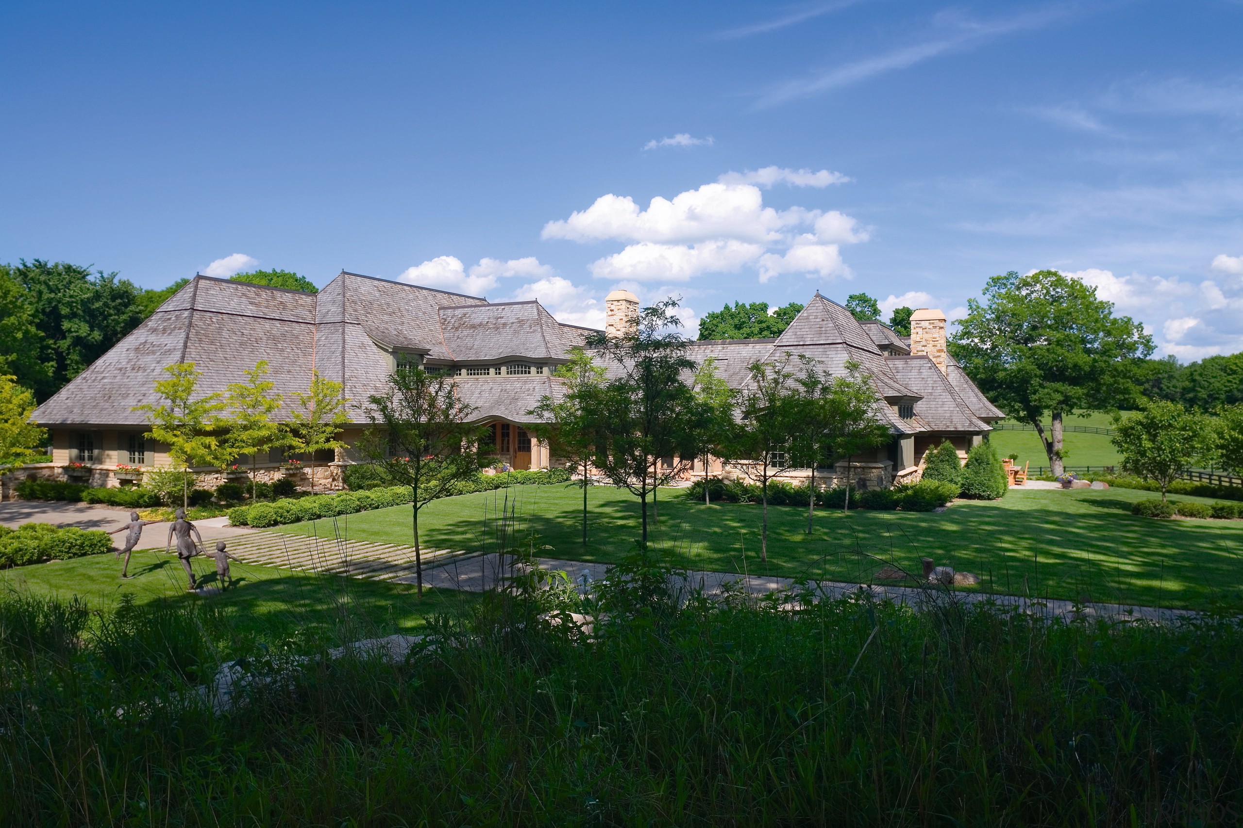 Steeply pitched roofs and sweeping eaves are characteristic cloud, cottage, estate, farm, farmhouse, field, grass, grassland, home, house, landscape, mansion, meadow, mount scenery, mountain, national trust for places of historic interest or natural beauty, pasture, property, real estate, rural area, sky, tree, village, green, teal