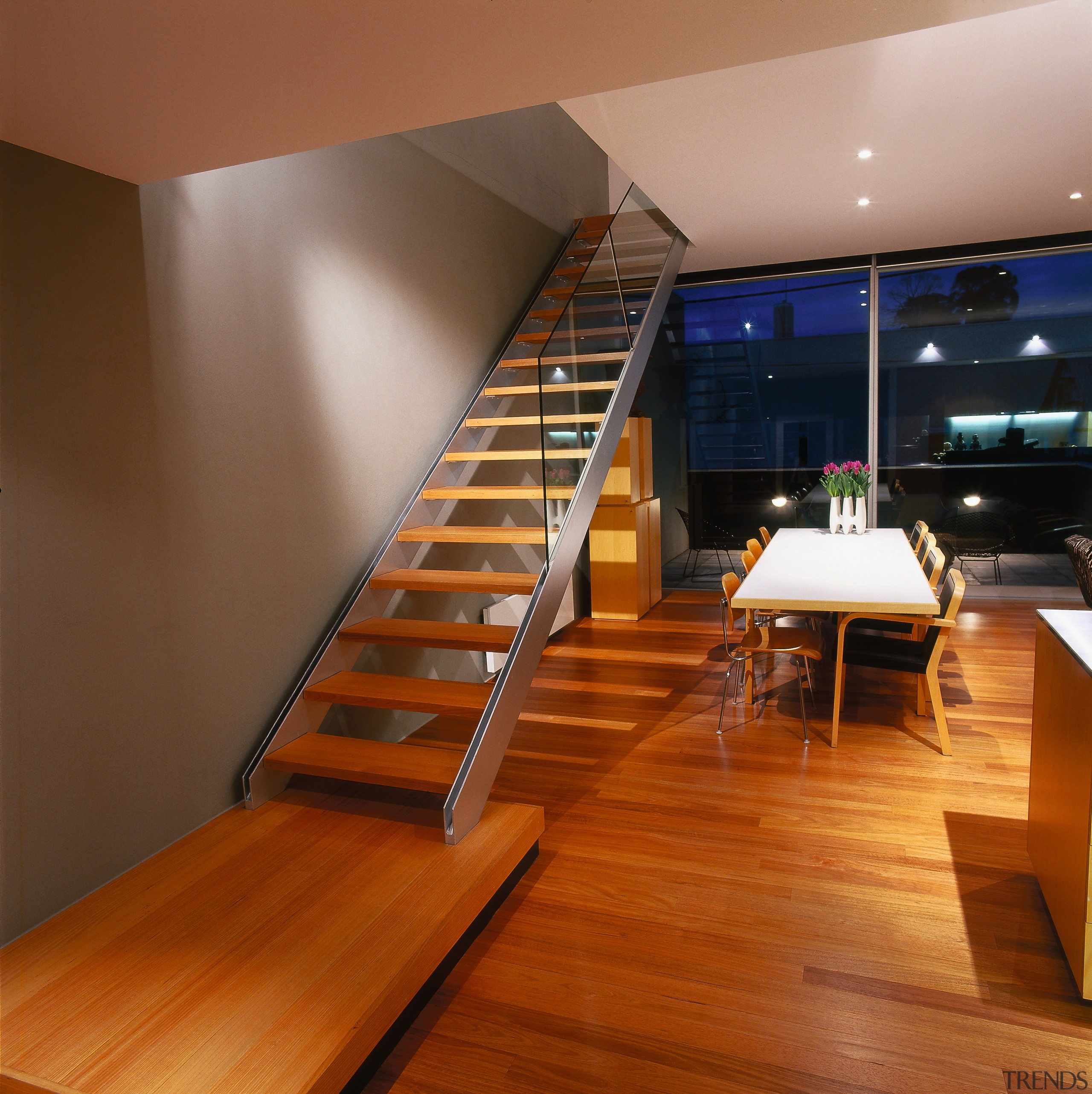 View of this home's main living area as architecture, floor, flooring, handrail, hardwood, interior design, stairs, wood, wood flooring, brown