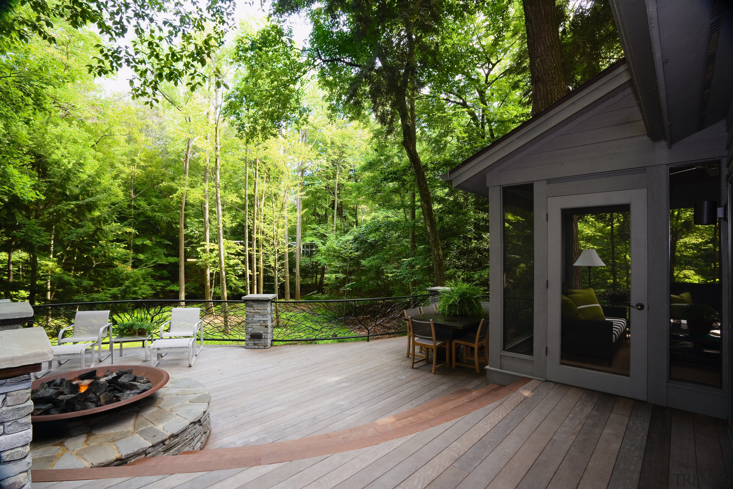 An exterior view of the deck and patio backyard, cottage, deck, home, house, landscape, outdoor structure, plant, porch, property, real estate, tree, walkway, yard, black