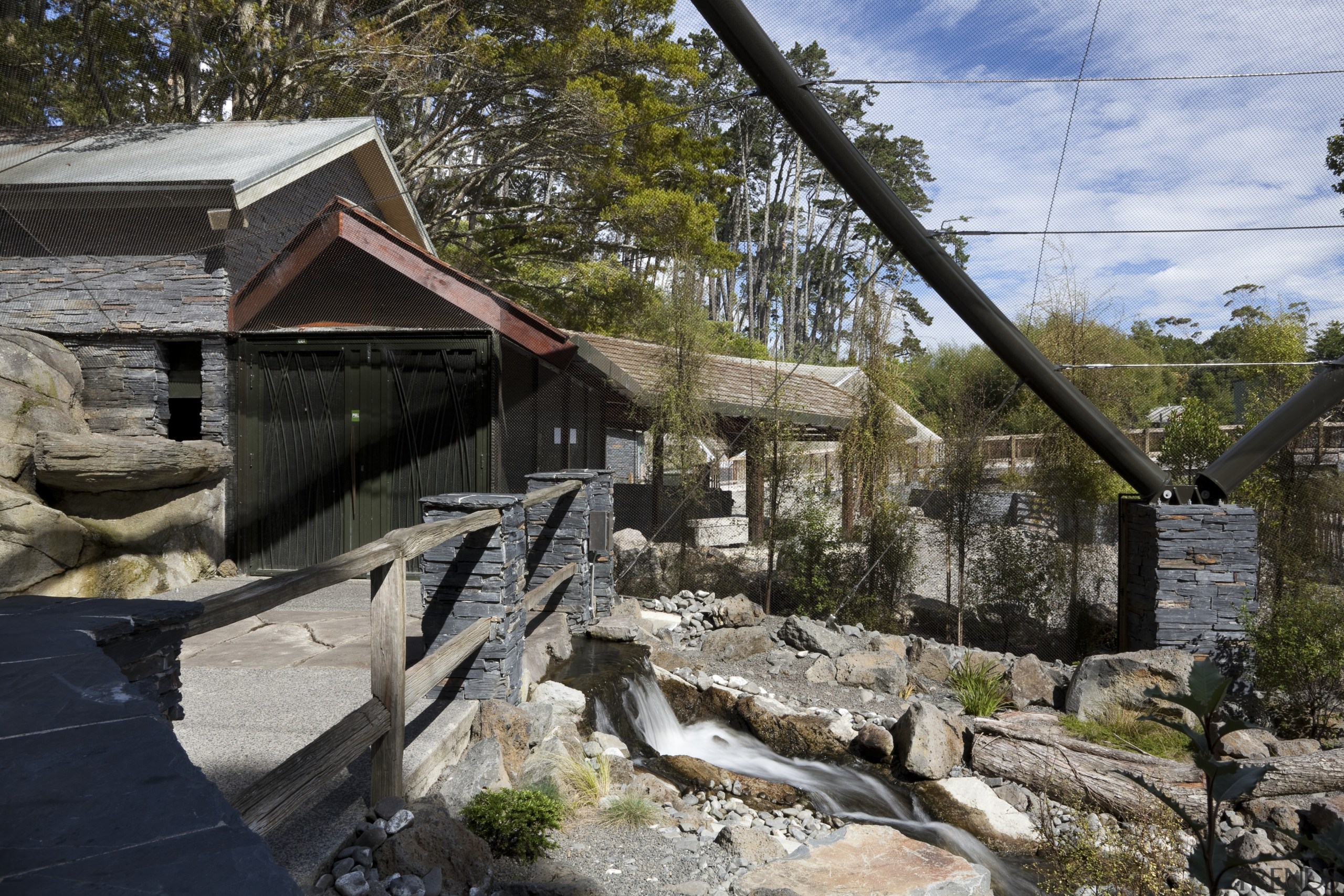 View of stone building and landscaping. - View cottage, tree, village, black, gray