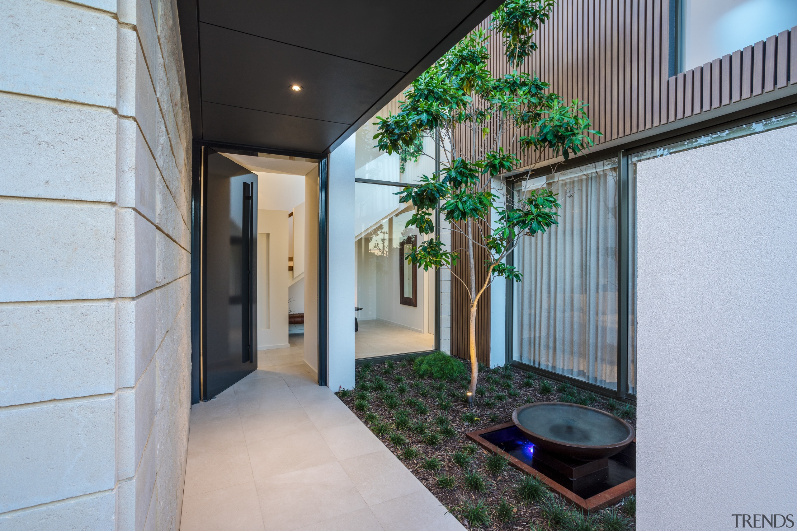 ​​​​​​​The sheltered entryway to this home includes a architecture, building, ceiling, courtyard, green, house, interior design, plant, property, real estate, room, tree, gray