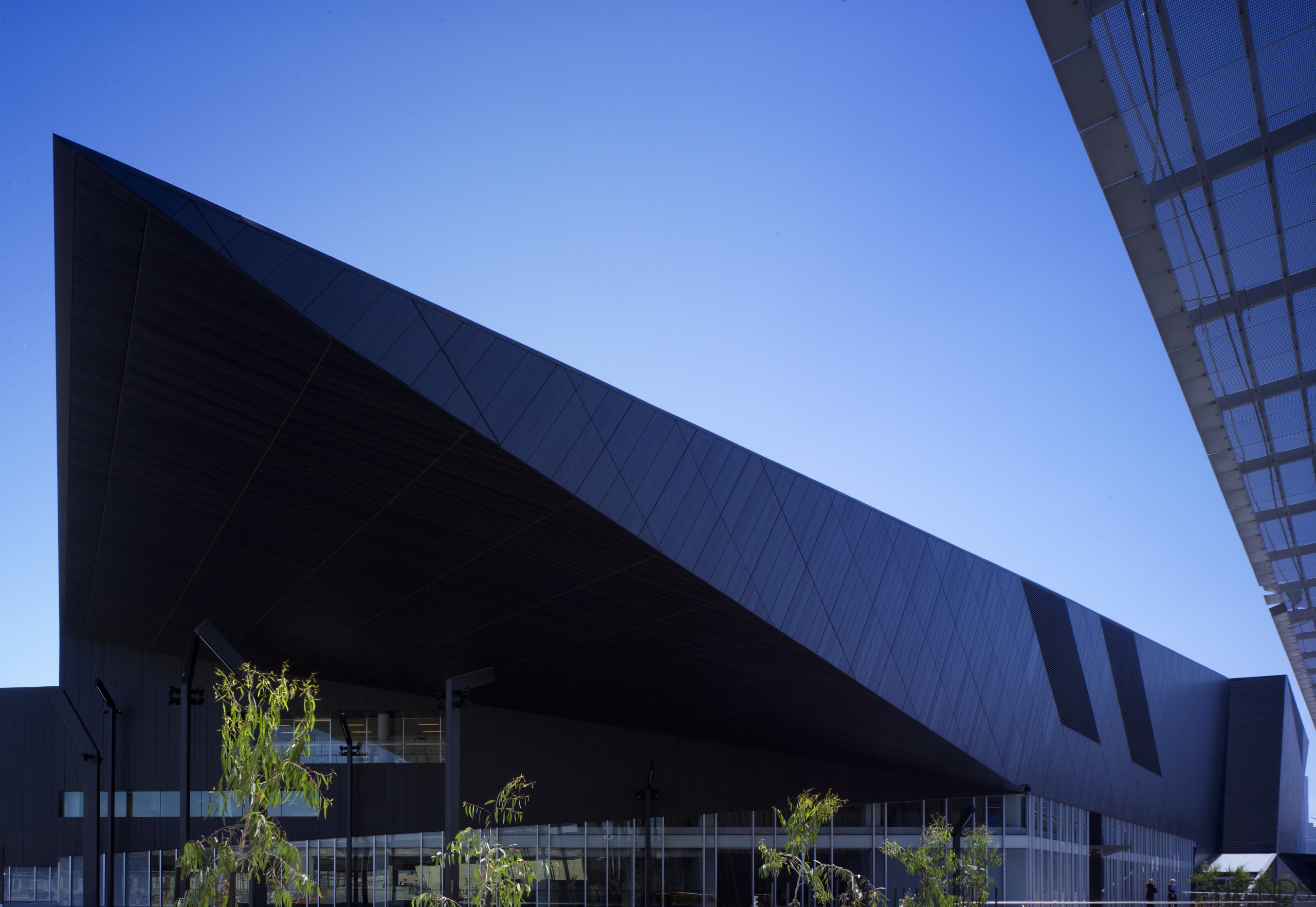 Exterior view of the Melbourne Convention Centre. - architecture, building, commercial building, convention center, corporate headquarters, daylighting, daytime, facade, headquarters, house, landmark, metropolitan area, reflection, roof, sky, structure, black, teal