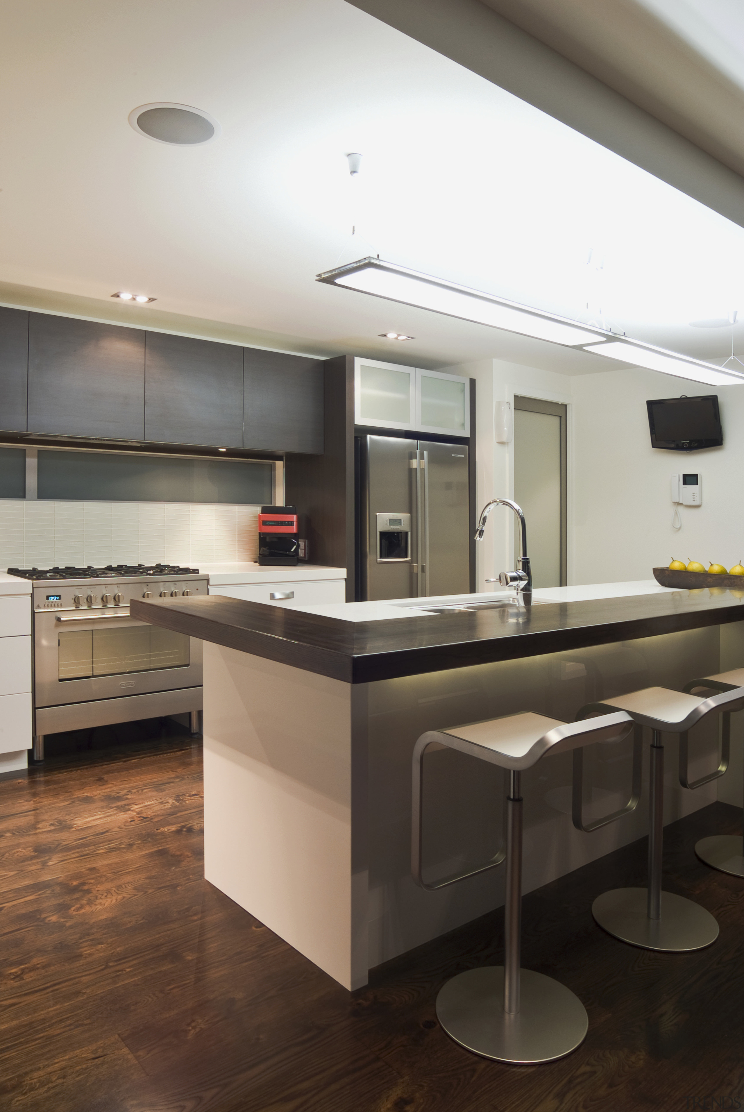 view of a new kitchen which features white cabinetry, countertop, floor, interior design, kitchen, room, white, black