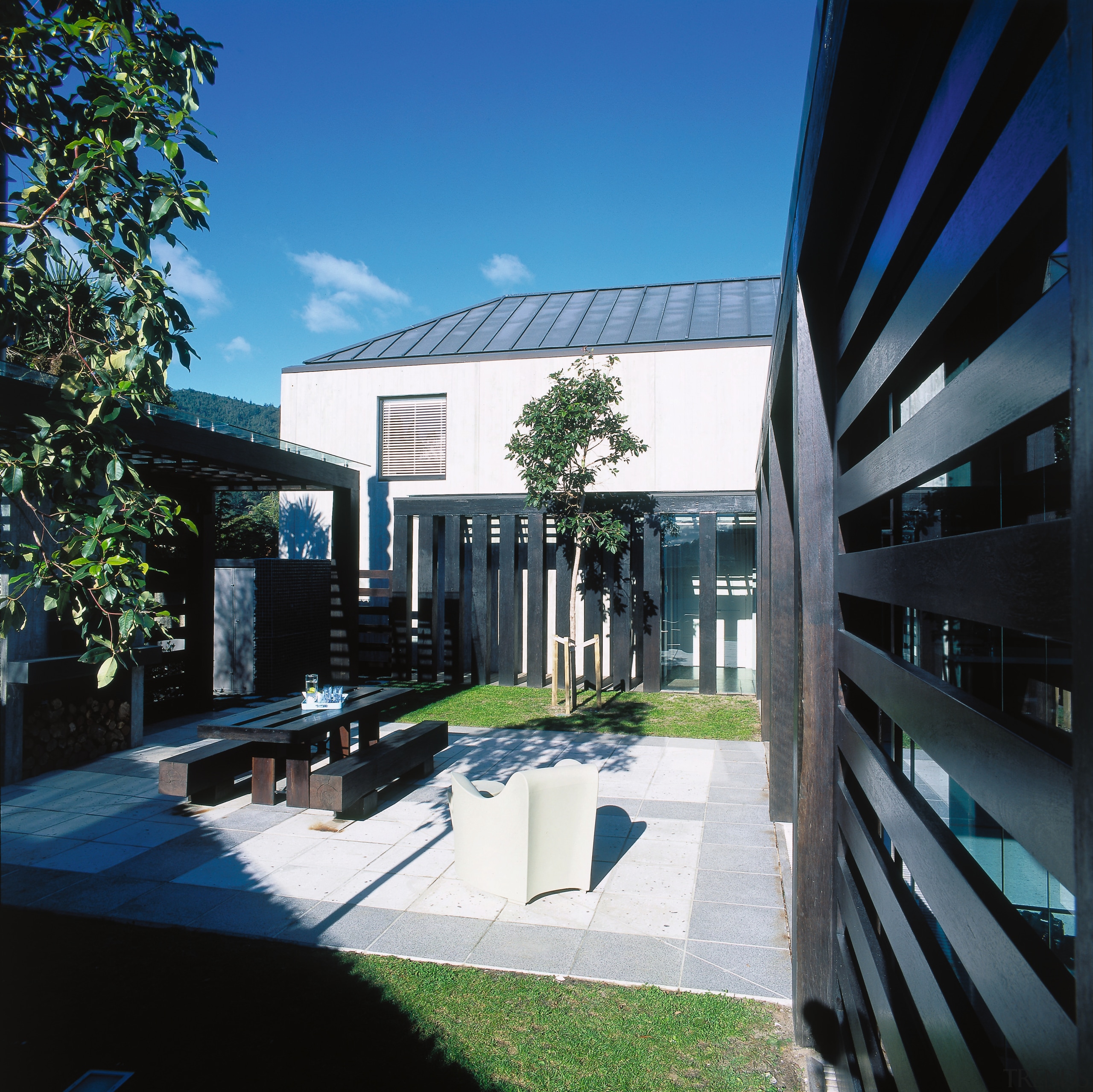 view of the outdoor courtyard featuring  pergola apartment, architecture, building, commercial building, condominium, corporate headquarters, daytime, estate, facade, headquarters, house, mixed use, property, real estate, residential area, black