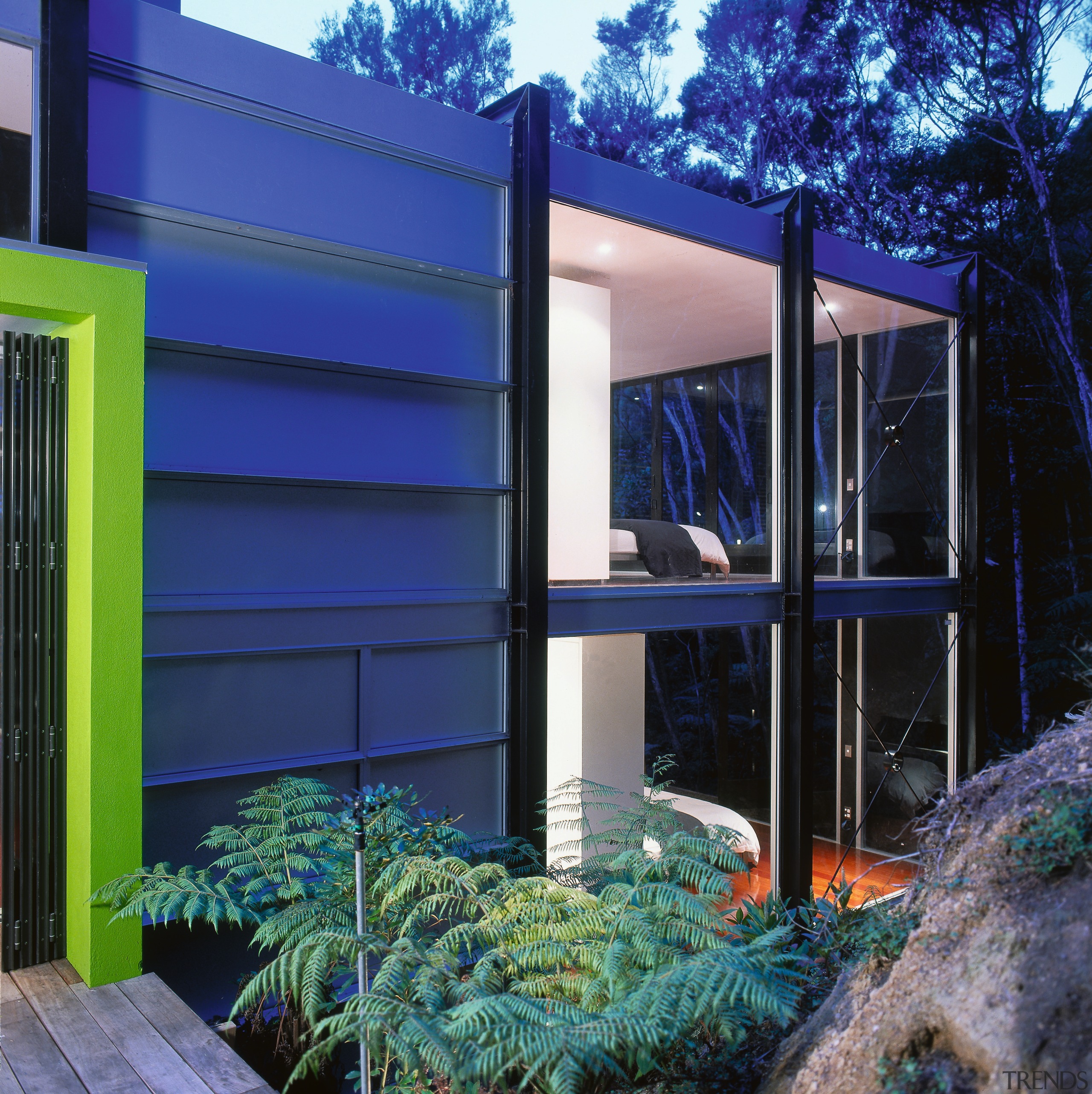 An exterior view of this architecturally designed housed architecture, backyard, elevation, facade, home, house, majorelle blue, property, real estate, residential area, siding, window, blue